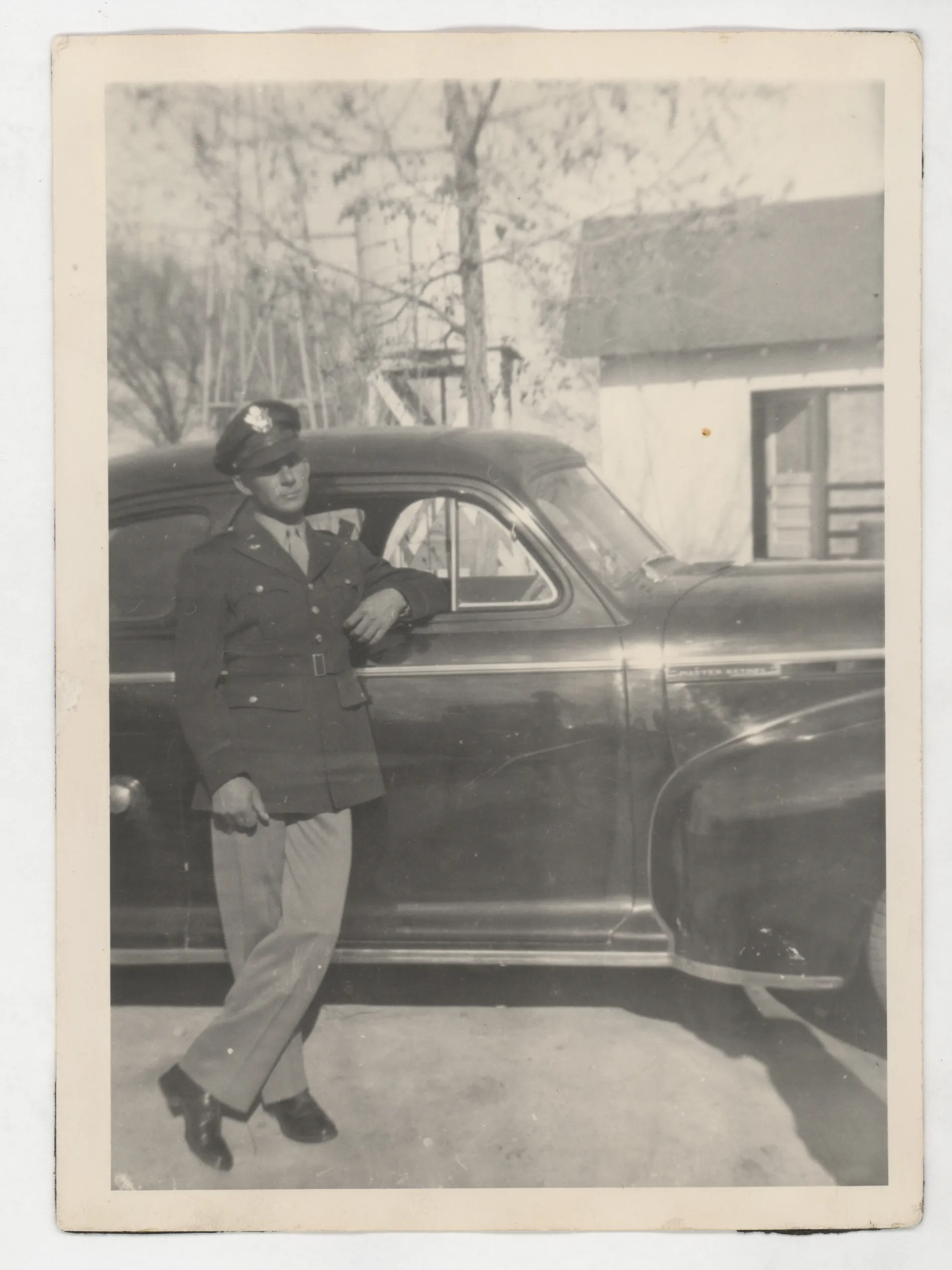 This photograph depicts Harold Allison standing next to a car in his military uniform shortly after being discharged from the military in 1945 following the conclusion of World War II.