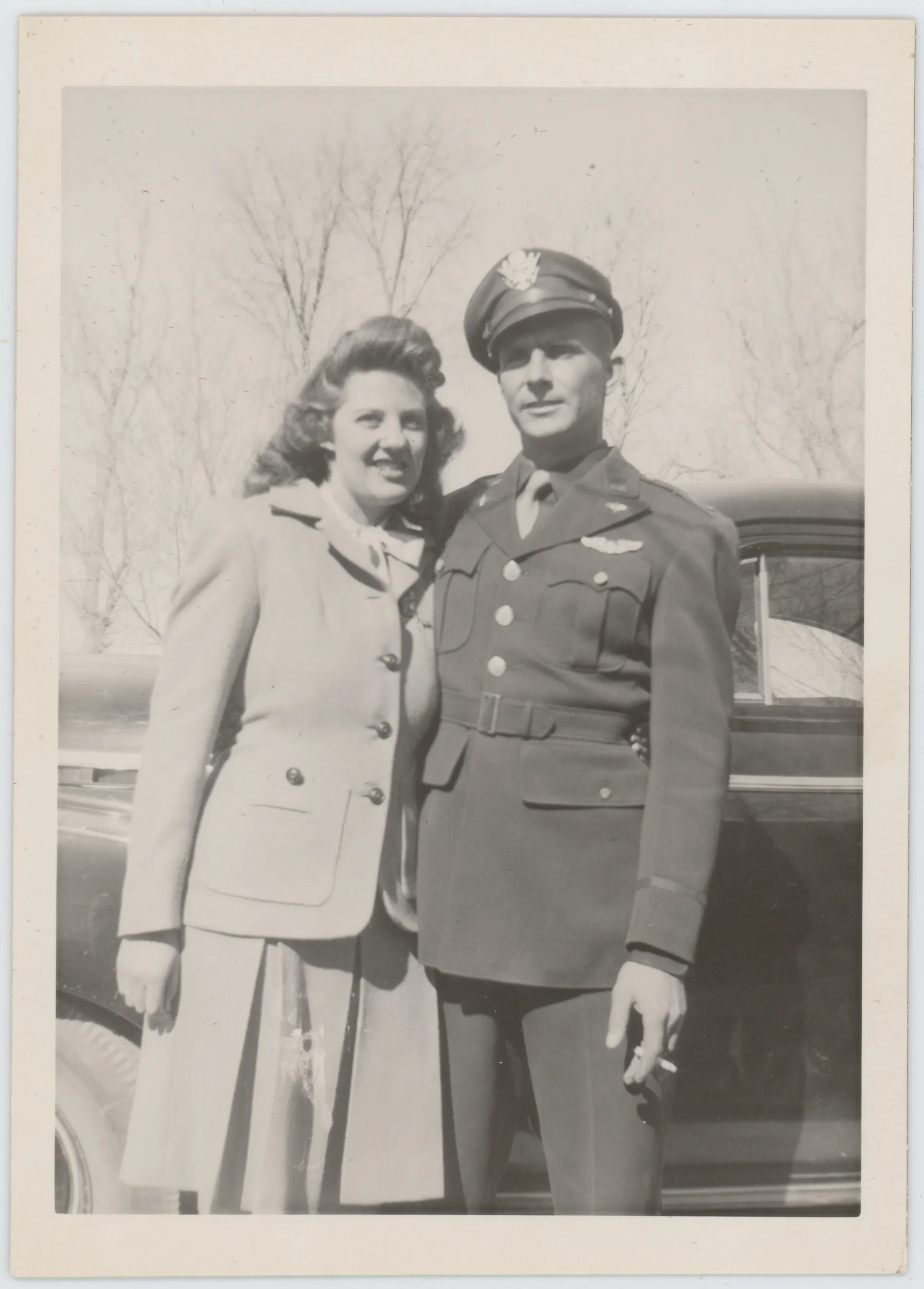 This photograph depicts Harold and Jean Allison standing next to a car likely at the home of Wiley and Ollie Grizzle. It appears that this photograph was taken shortly after Jean and Harold got married and left New Mexico for a period while Harold was on active duty.