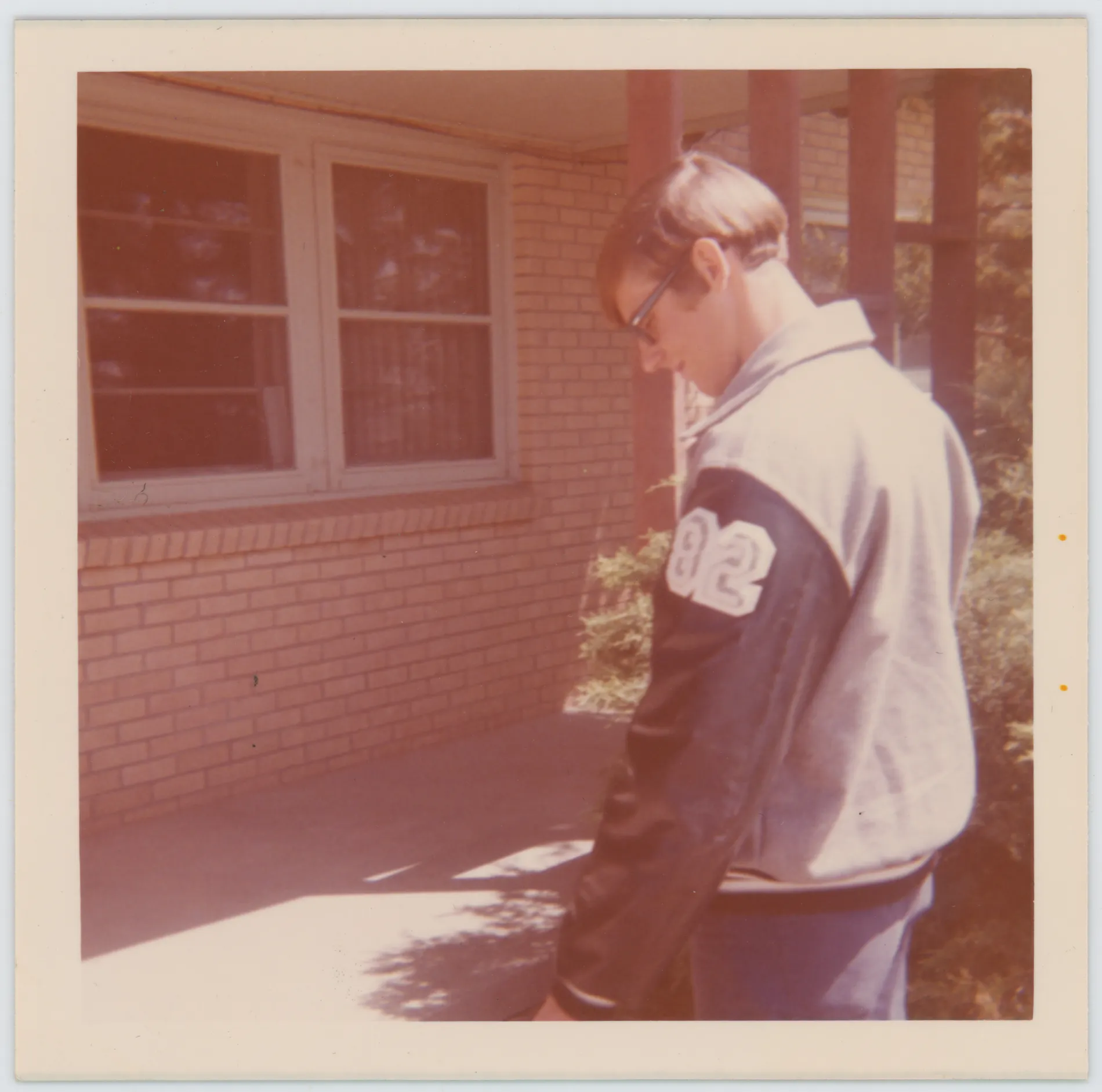 This photograph depicts Jack standing in front of his Lamb County home wearing his Muleshoe High School letterman jacket.