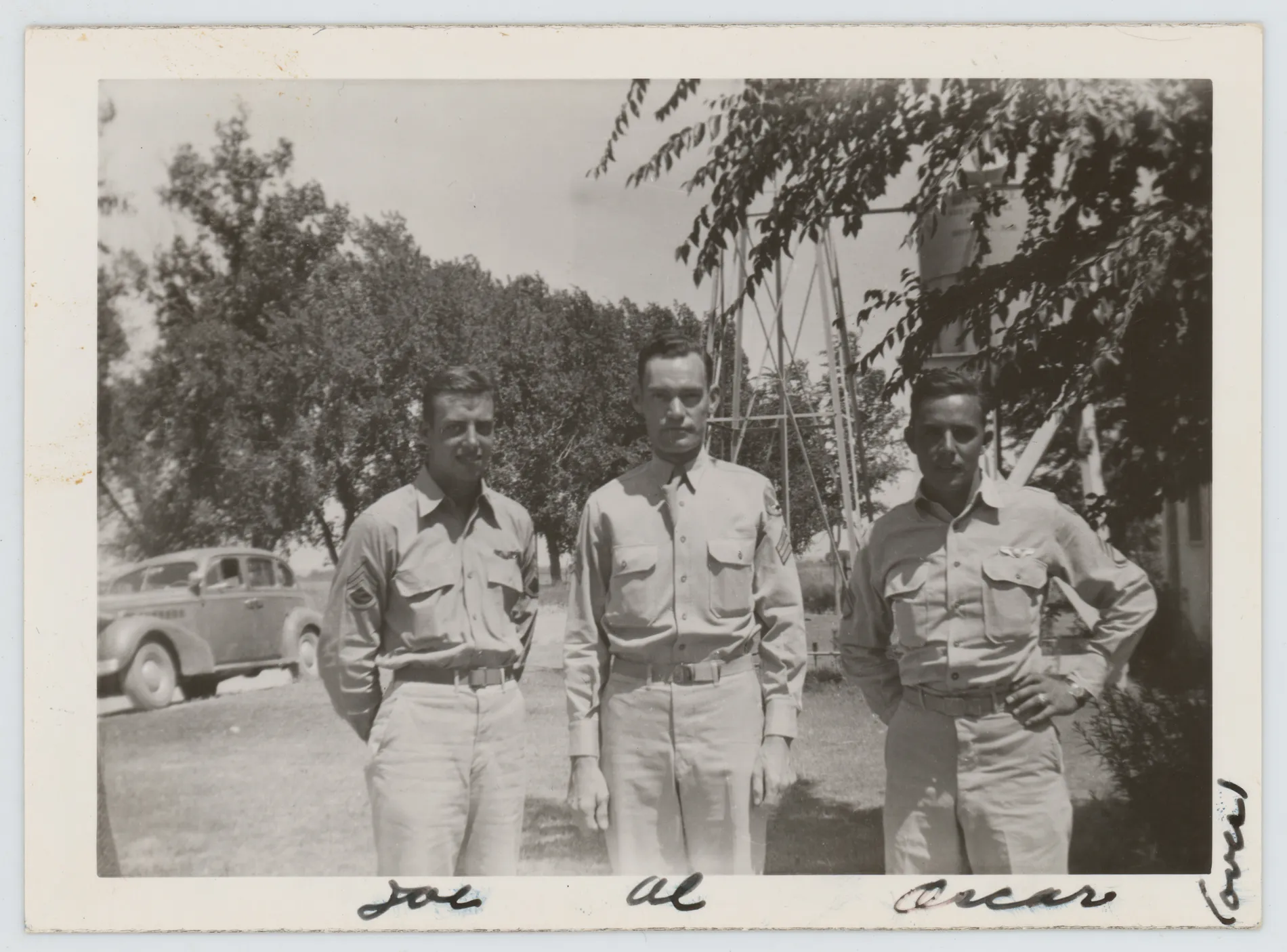 This photograph depicts Oscar Allison standing with two other men identified as Joe and Al. The water tower in the background is labeled "Roswell, N.M.", so this must be before Oscar deployed to Europe.
