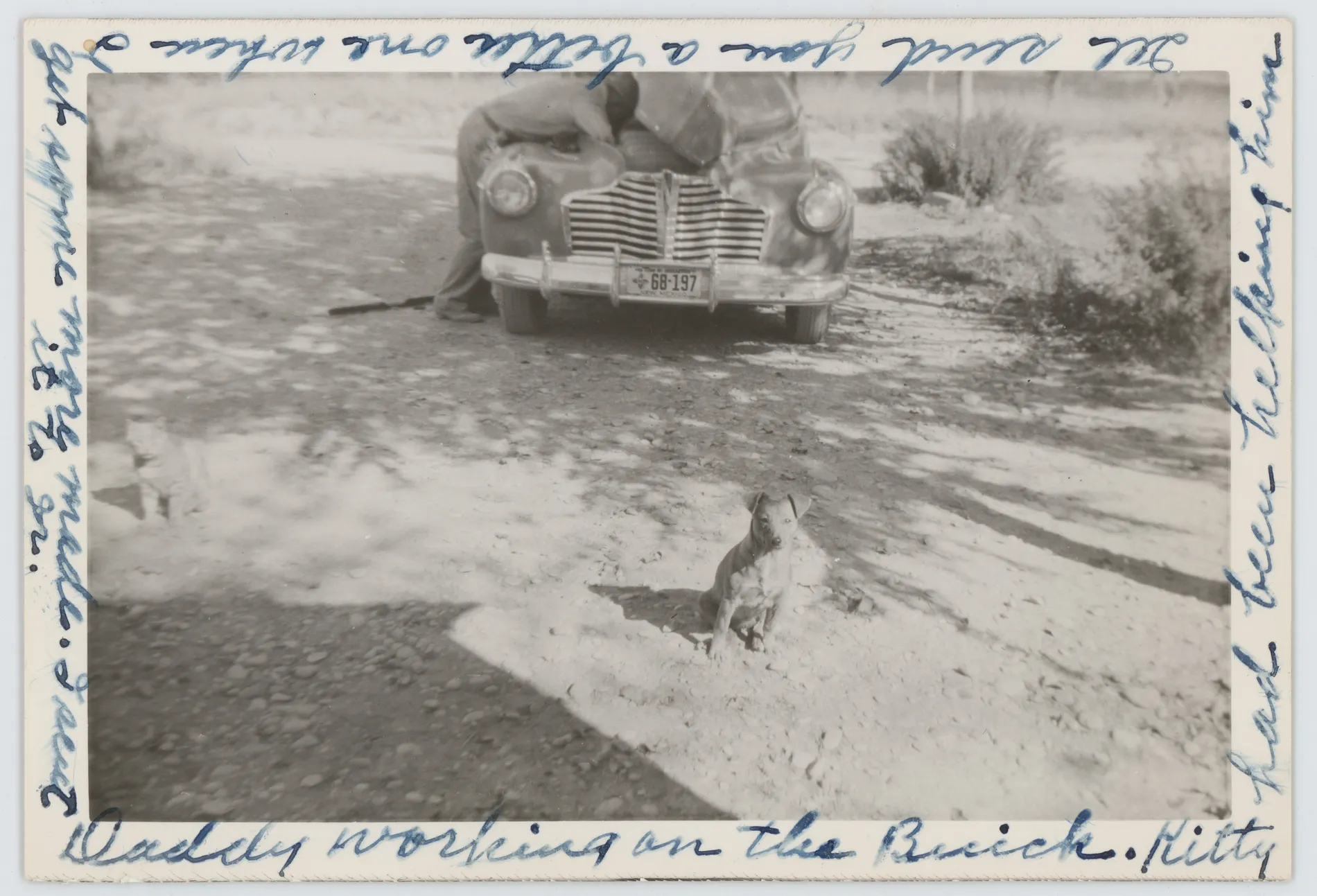 This photograph depicts Wiley Grizzle working on a Buick car.