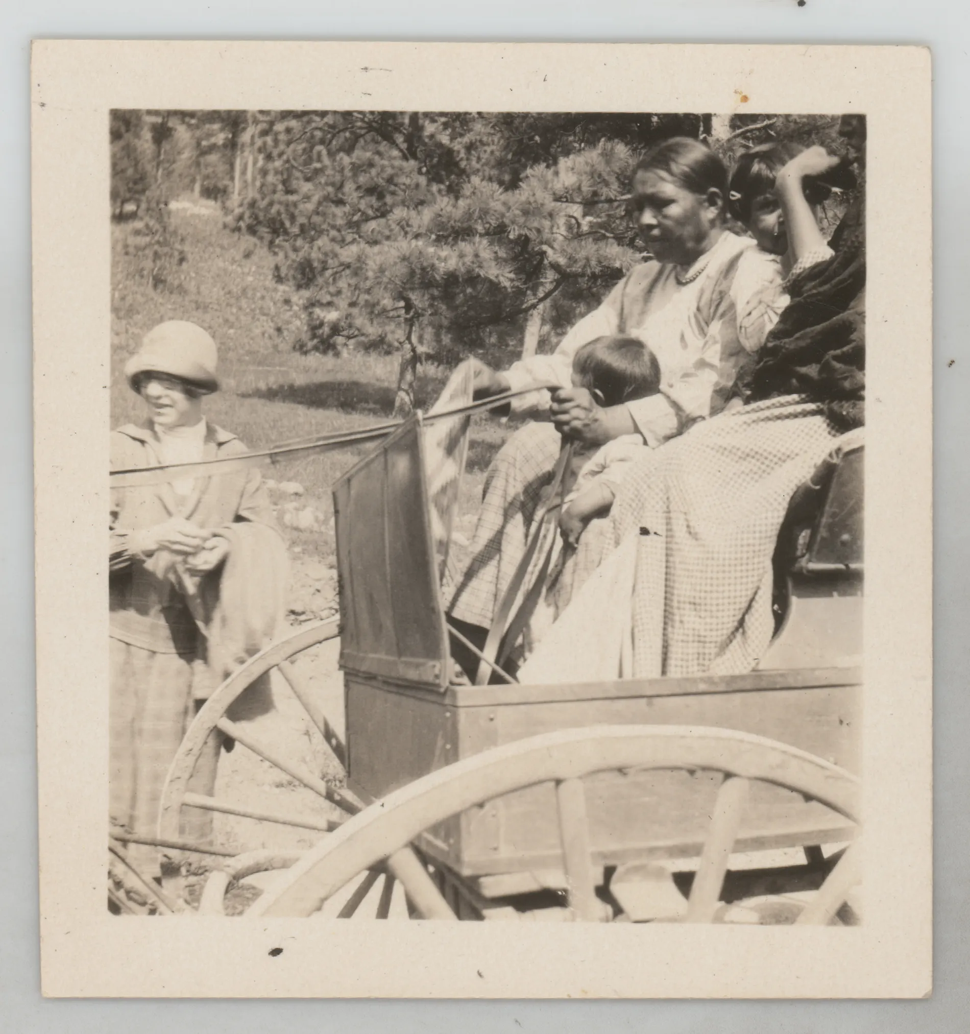 This photograph depicts Sammy McKinstry in a wagon driven by Native Americans. Minnie Swann McKinstry is at the left.