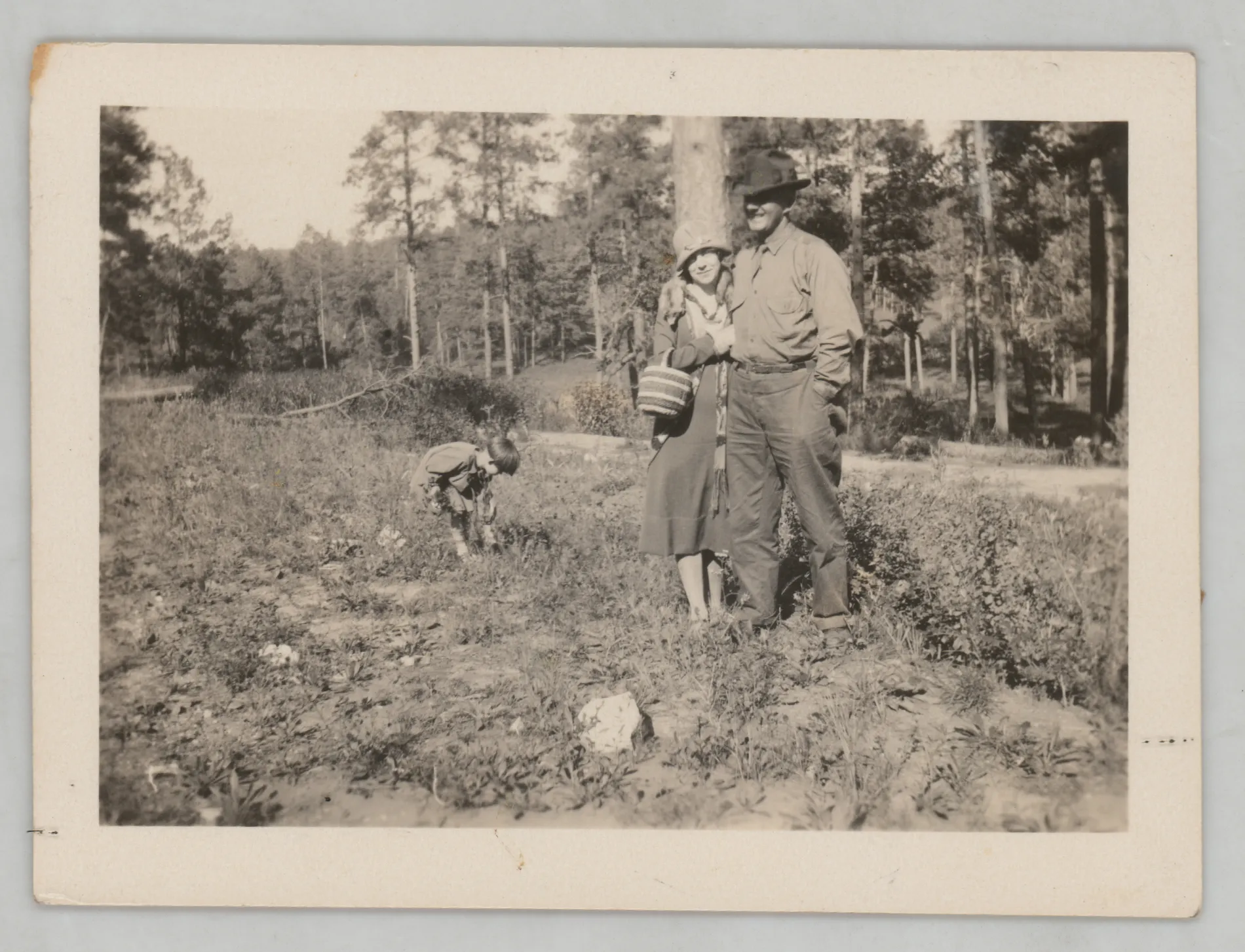This photograph depicts Sam, Loveta, and Sammy McKinstry in a New Mexico forest.