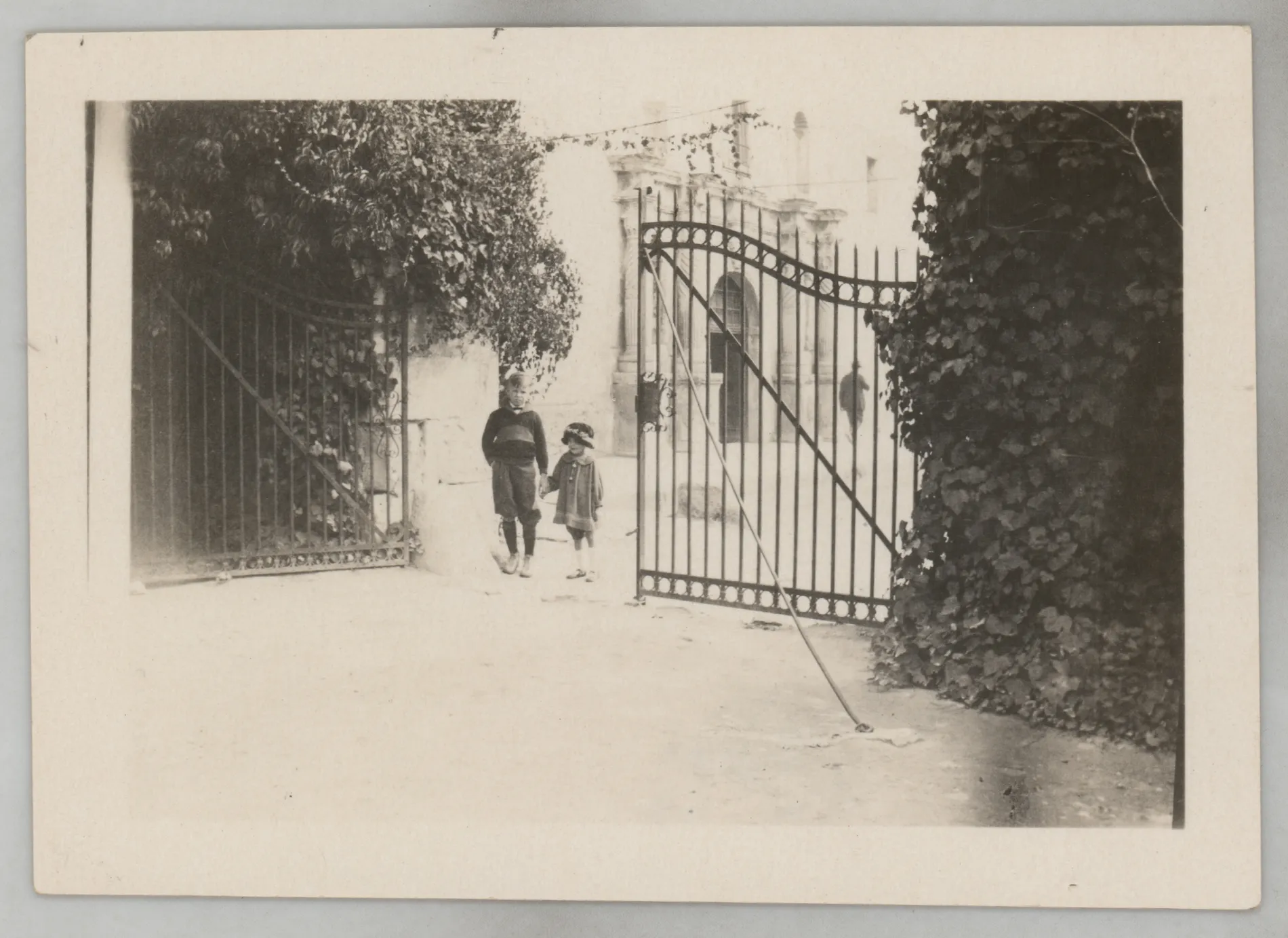 This photograph depicts Sammy McKinstry and an unknown boy holding hands near the Alamo in San Antonio, Texas.