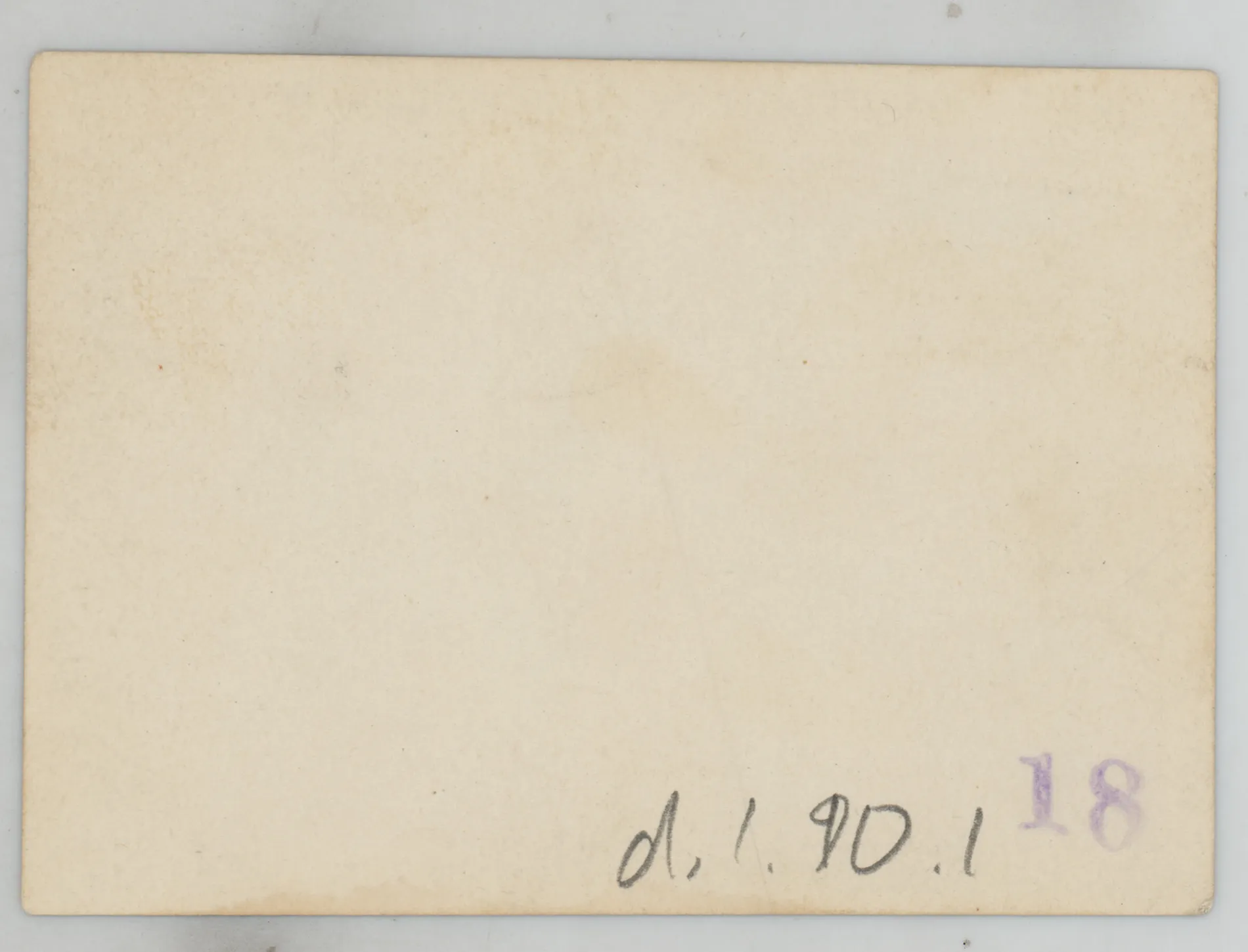 Verso: [Sammy McKinstry standing next to a house]
