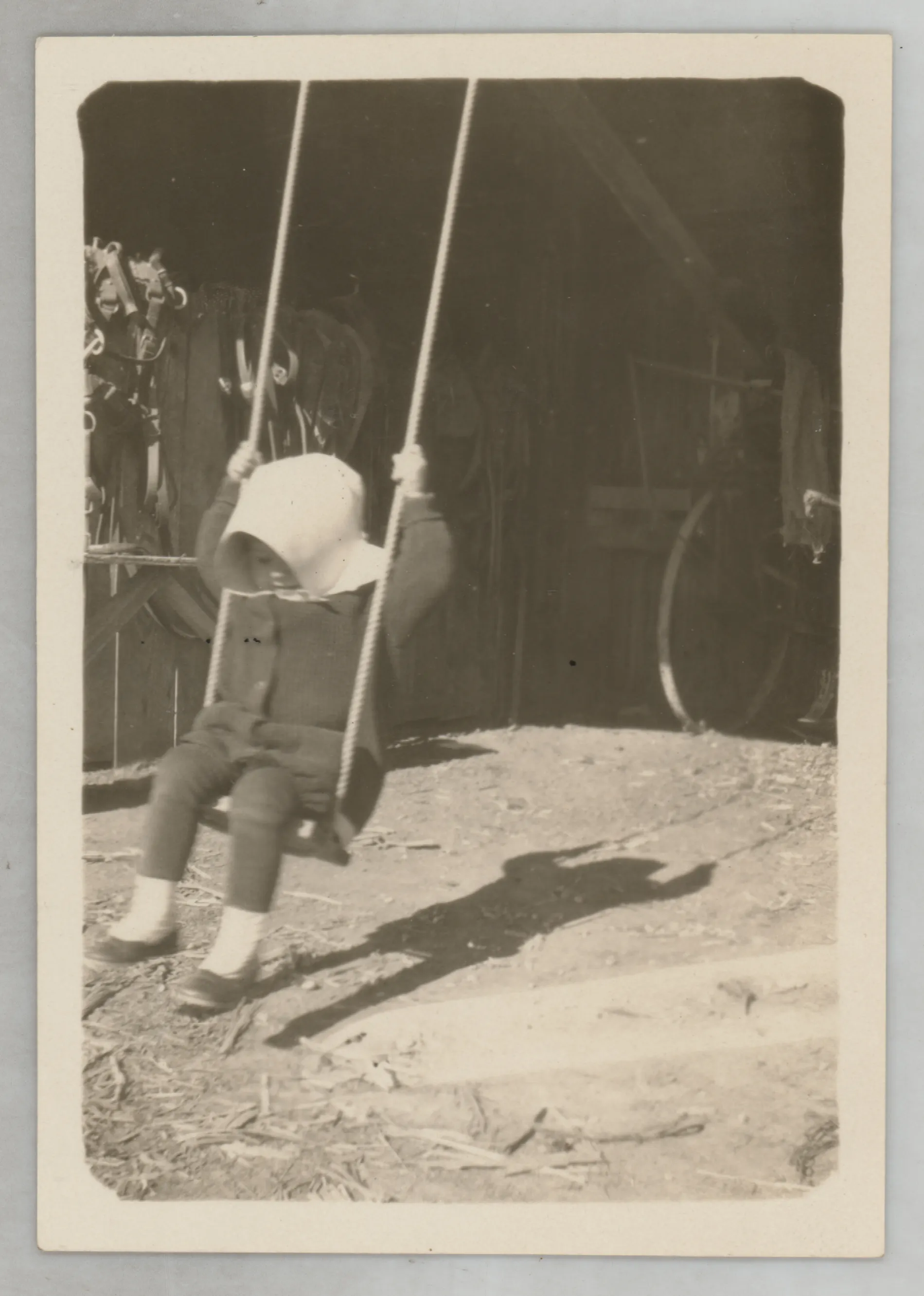 This photograph depicts Sammy McKinstry swinging on a swing.