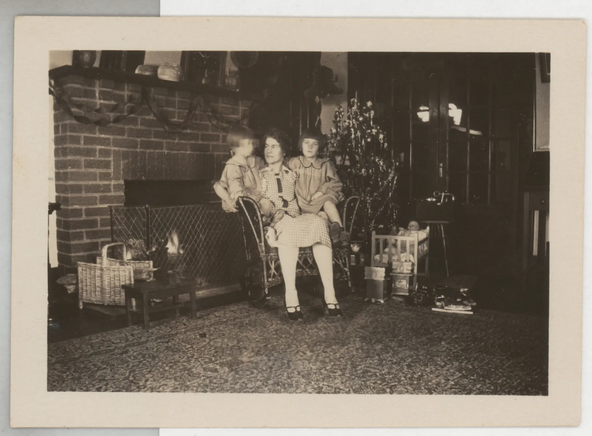 This photograph depicts Loveta Swann McKinstry holding Jean and Sammy at Christmas in 1924 at the McKinstry home in Hagerman, New Mexico.