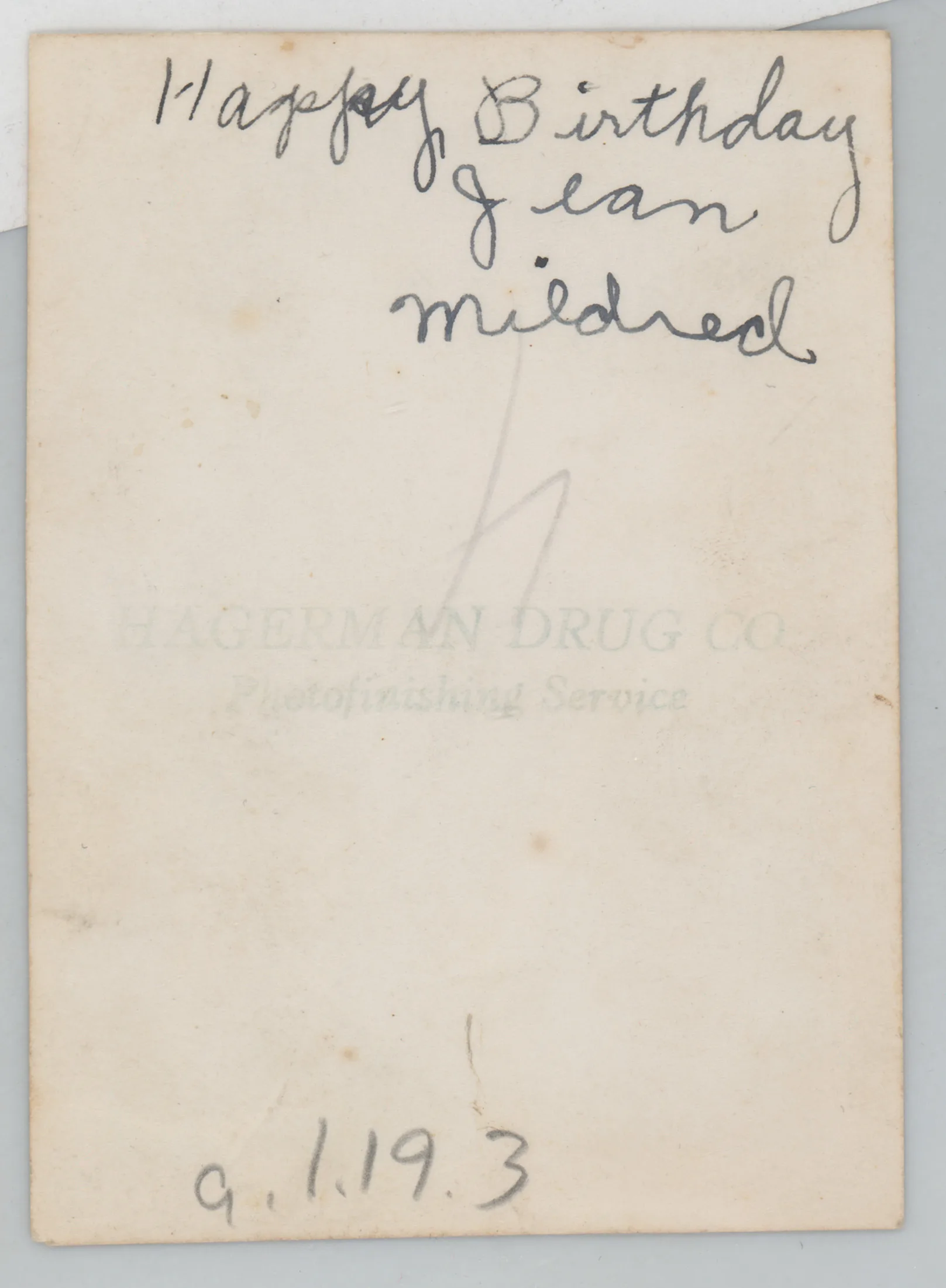 Verso: [Jean and Mildred holding hands in front of a house]