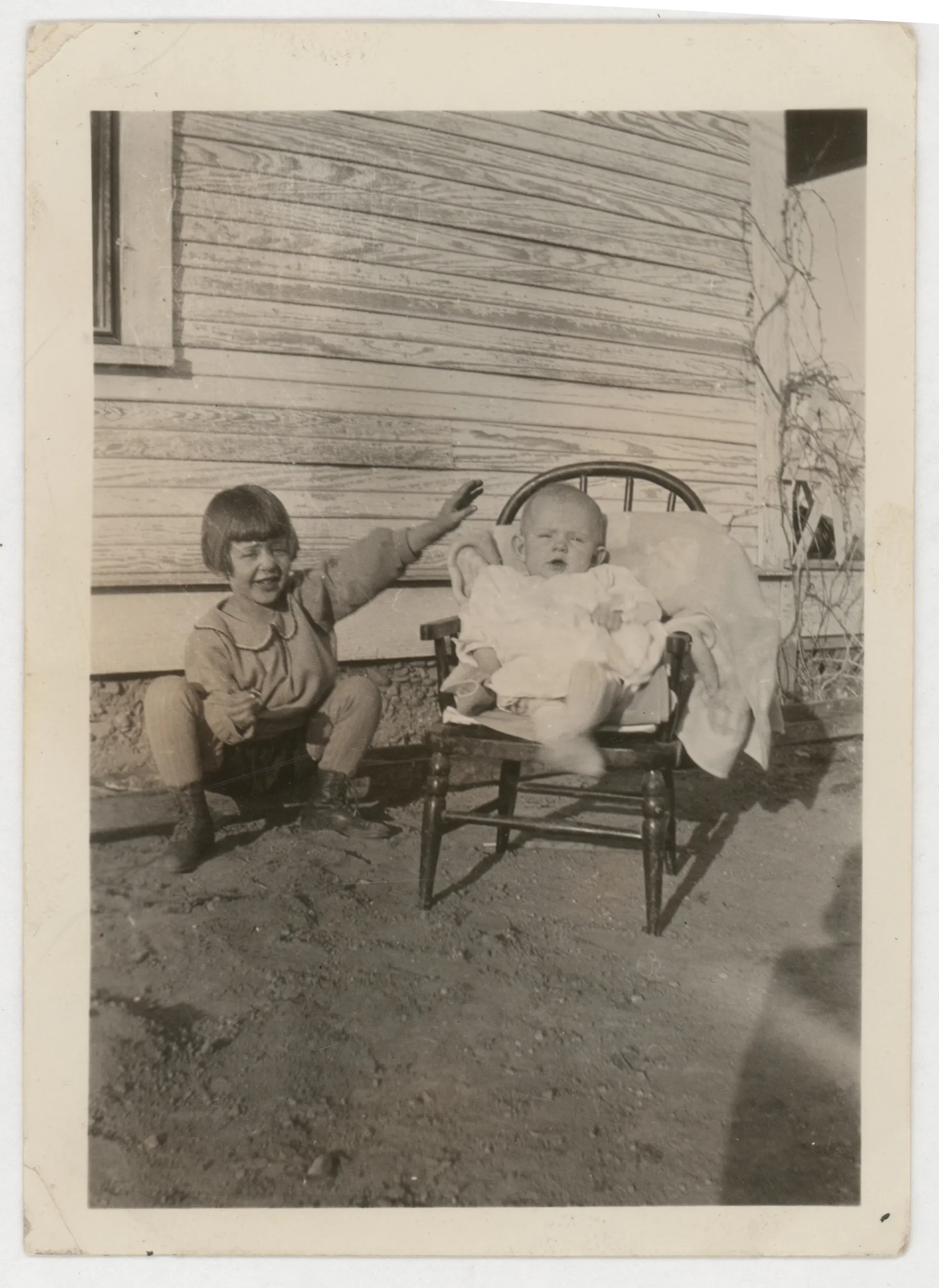 This photograph depicts Jean and Peggy McKinstry. Peggy is in a chair with Jean on the left.