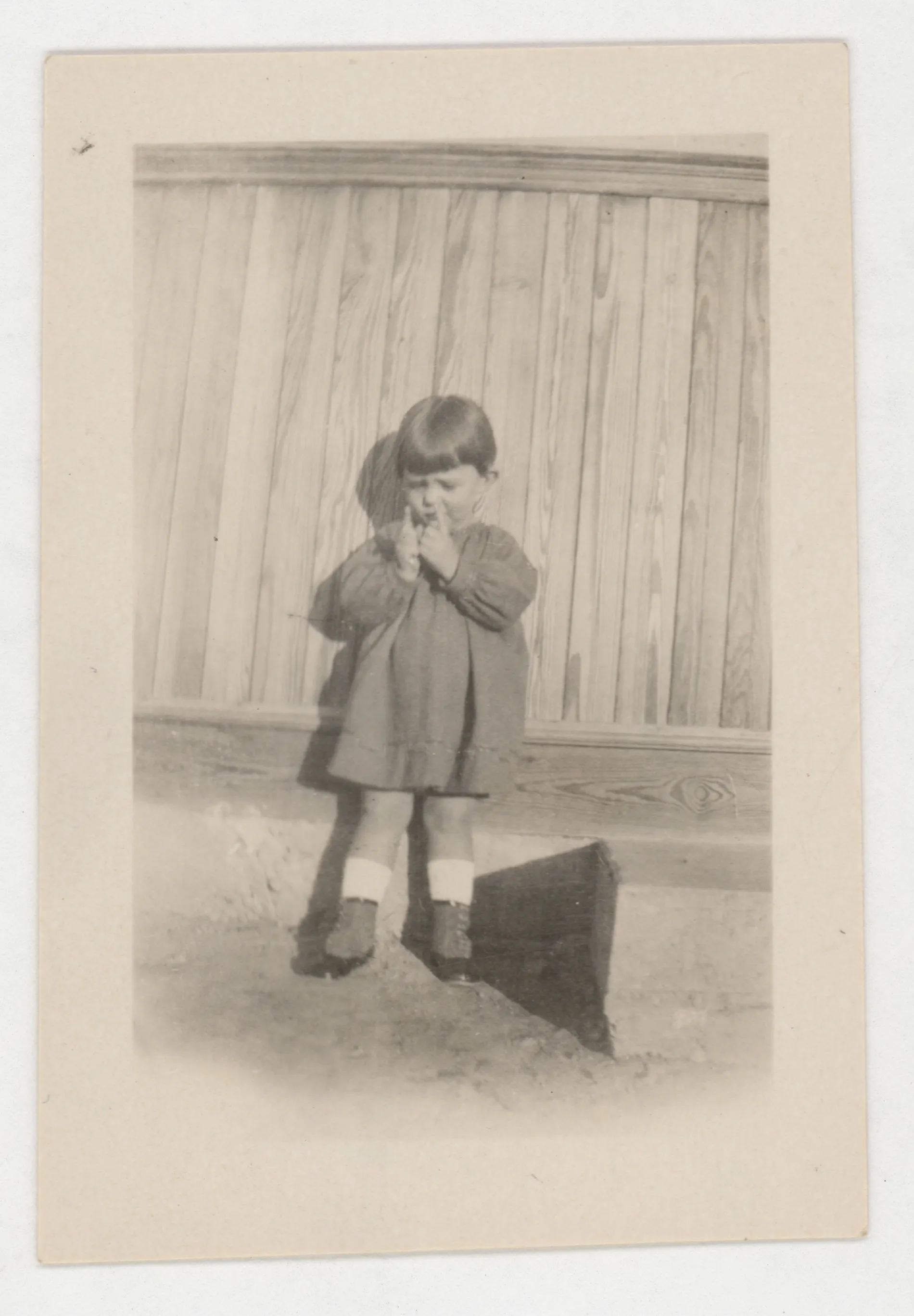 This photoraph depicts Jean McKinstry standing next to a structure.