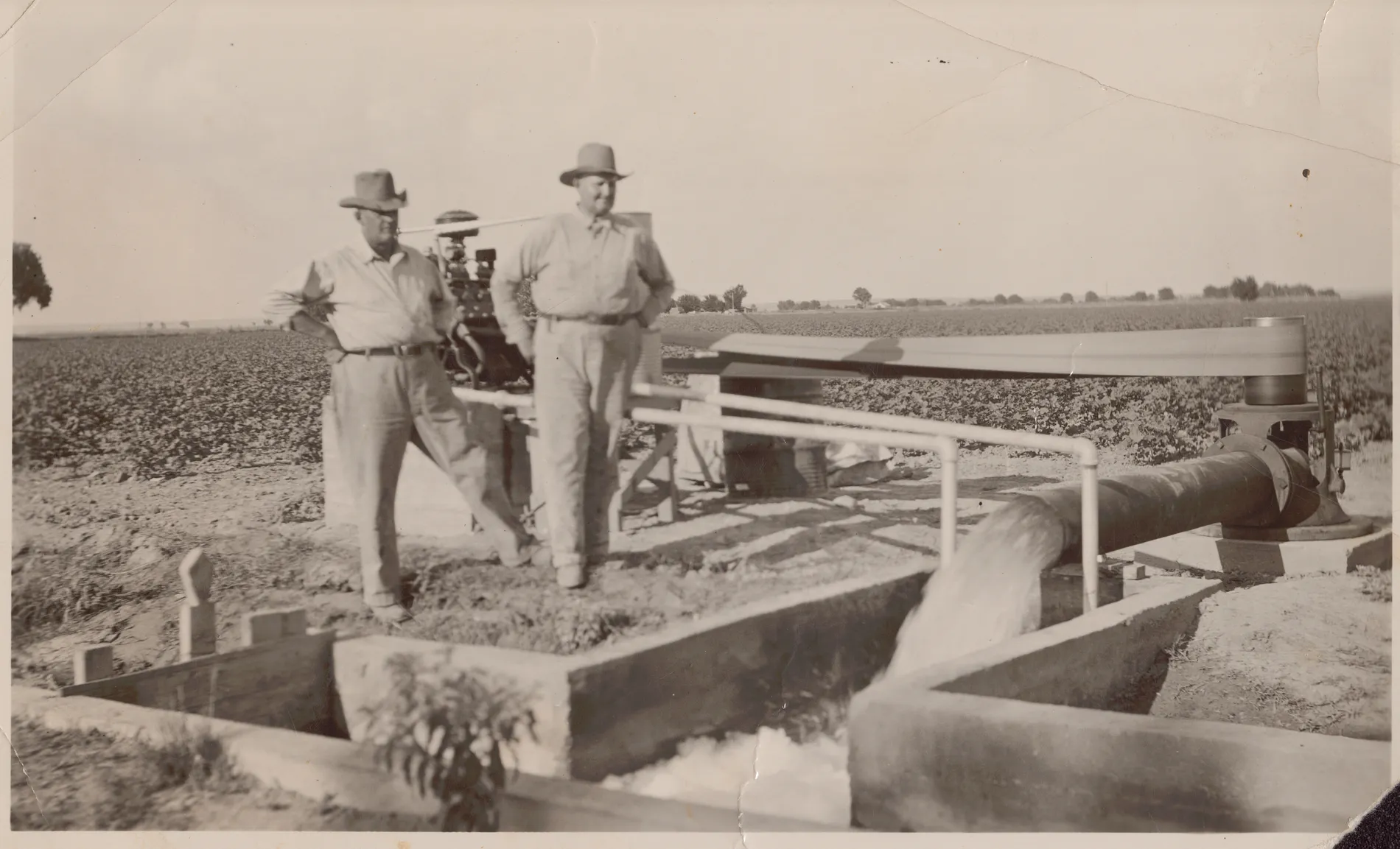 This photograph depicts Jim and Sam McKinstry standing next to a new irrigation well on their land near Hagerman, New Mexico.