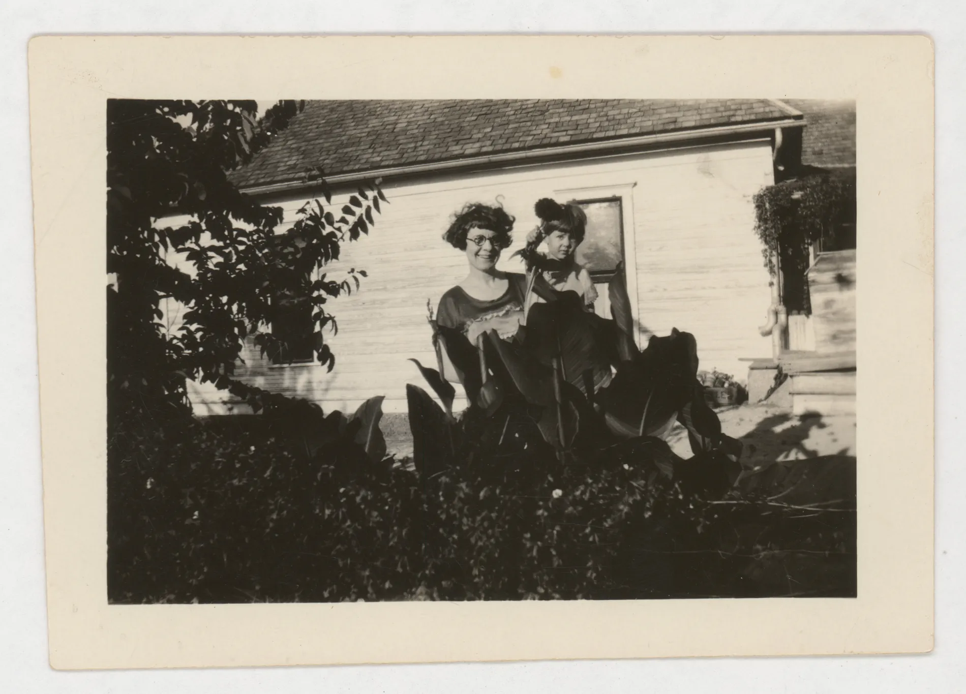 This photograph depicts Minnie Swann McKinstry holding her niece Jean McKinstry outside of a structure.