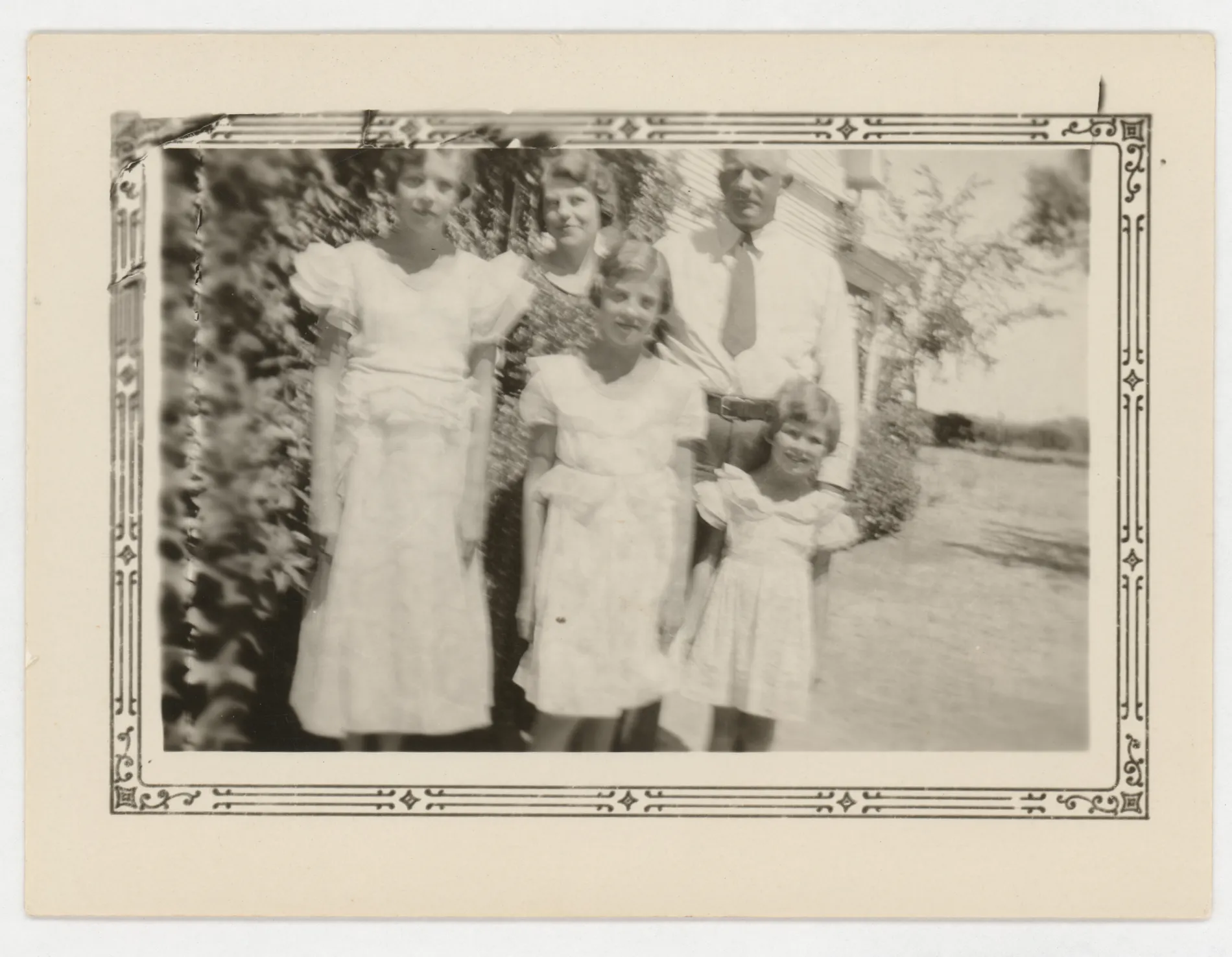 This photograph depicts Sam and Loveta McKinstry with their children in front of their Hagerman, New Mexico home. Sam and Loveta are standing in the back, and Sammy, Jean, and Mildred are standing in the front.