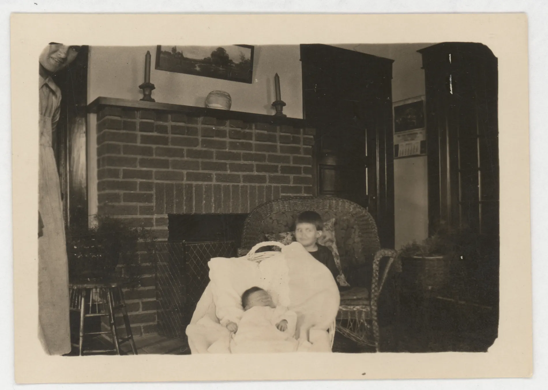This photograph depicts Sammy and Jean McKinstry next to a fireplace in the home of their parents, Sam and Loveta McKinstry