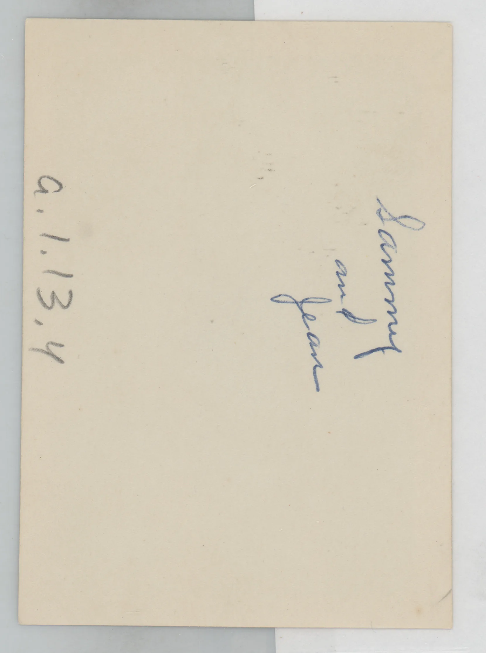 Verso: [Sammy and Jean McKinstry next to fireplace]