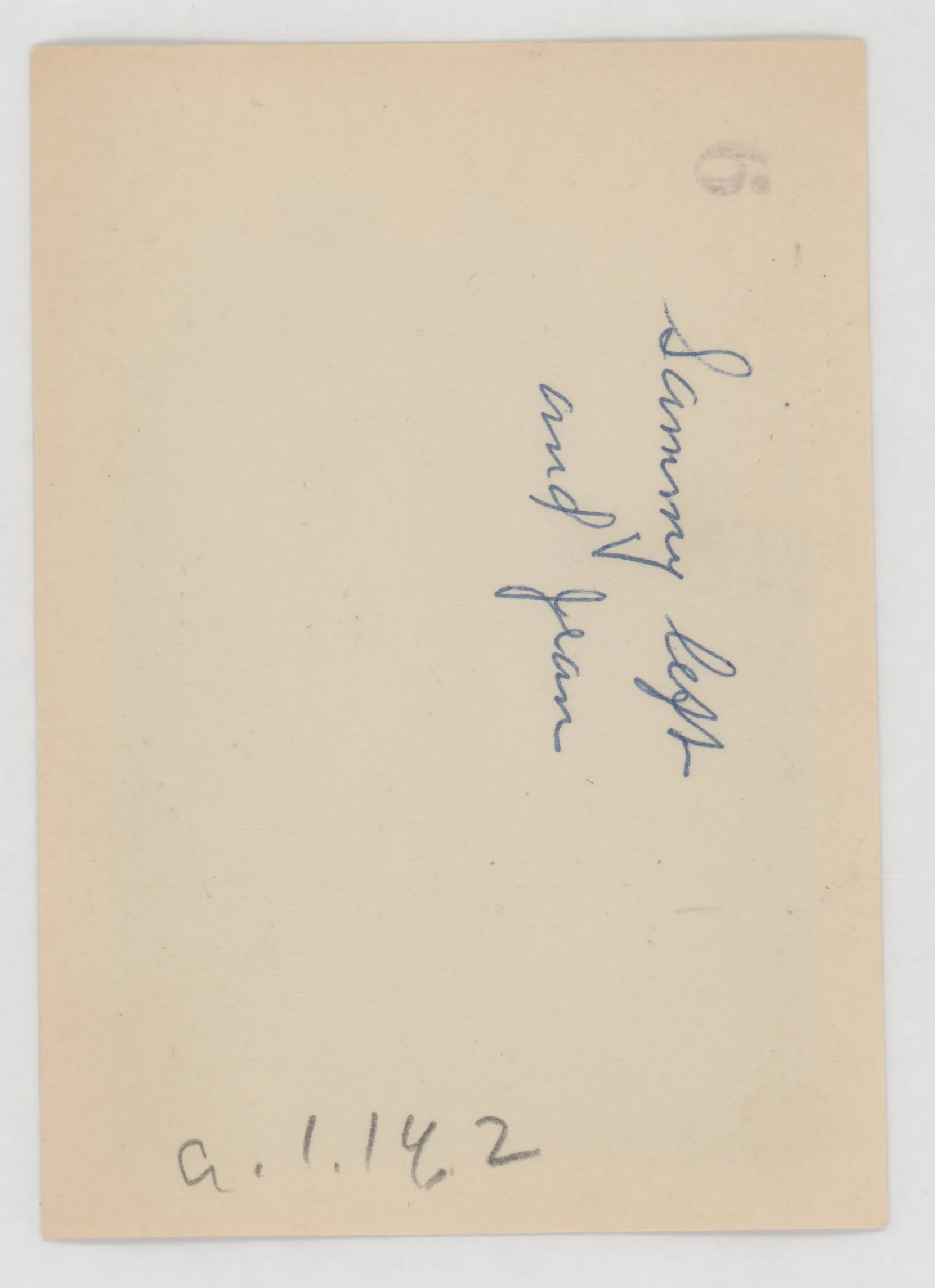 Verso: [Sammy and Jean McKinstry next to fireplace]