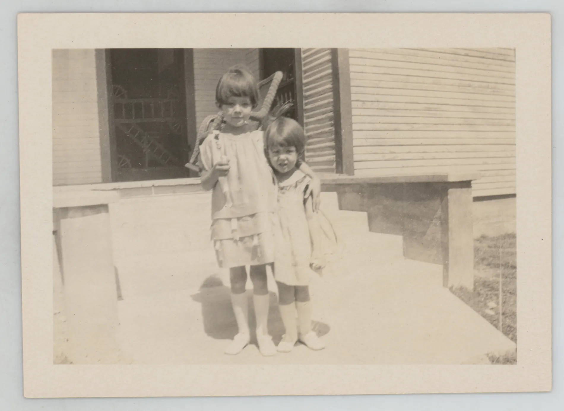 This photograph depict Sammy and Jean McKinstry standing next to a porch at their home in Hagerman, New Mexico.