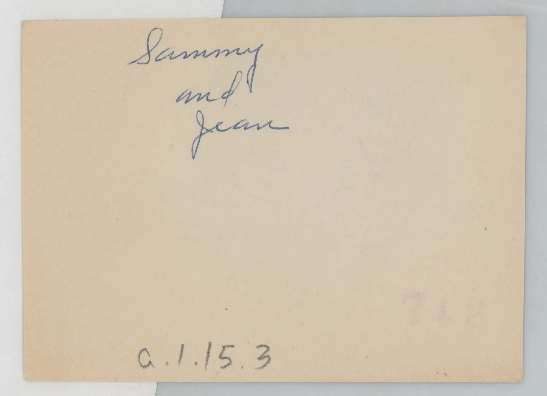 Verso: [Sammy and Jean McKinstry standing next to a porch]