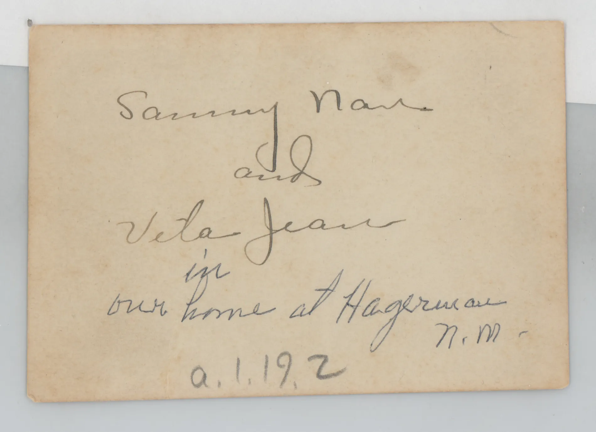 Verso: [Sammy and Jean McKinstry in a chair]