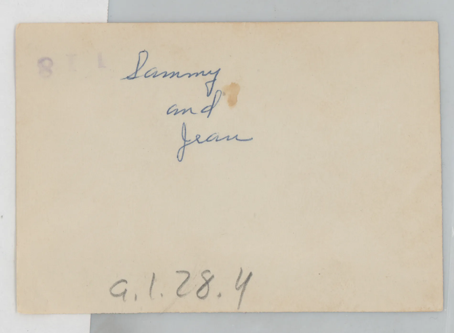 Verso: [Sammy and Jean McKinstry next to flowers]