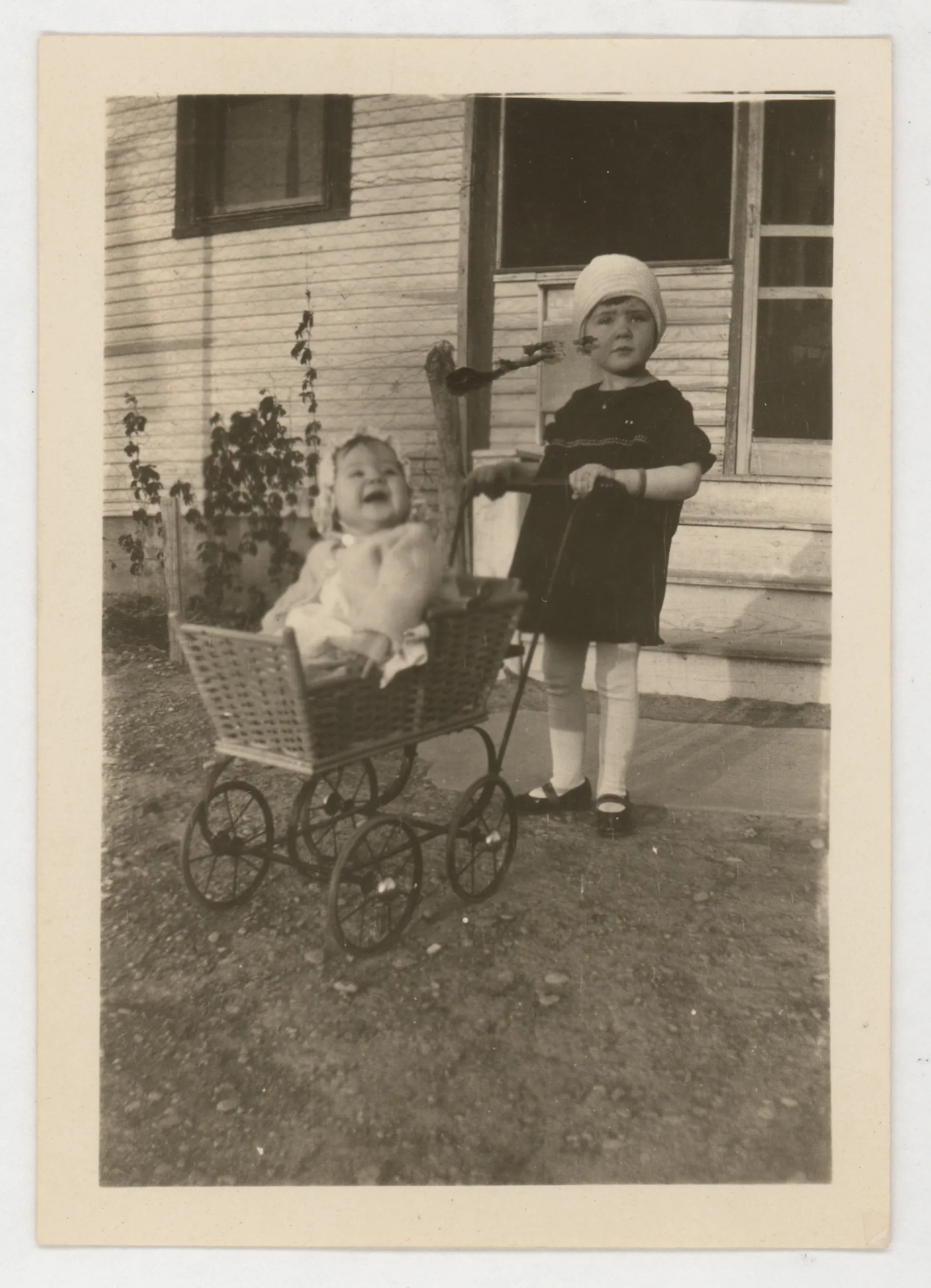 The photograph depicts Jean McKinstry in a stroller with Sammy McKinstry standing behind it as if pushing the stroller.
