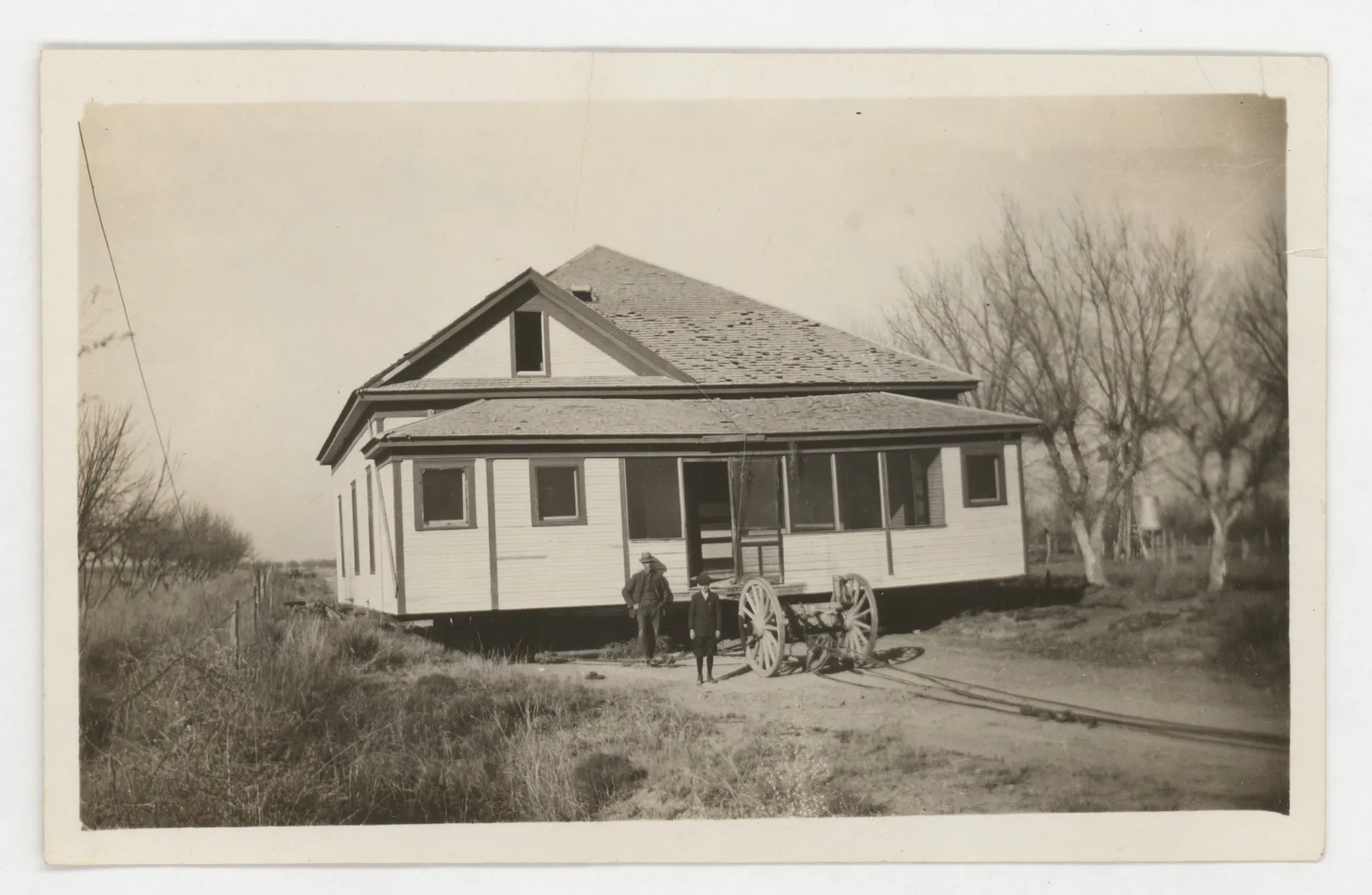 This photograph depicts the third home of Sam and Loveta McKintsty being moved from Greenfield, New Mexico to Hagerman.