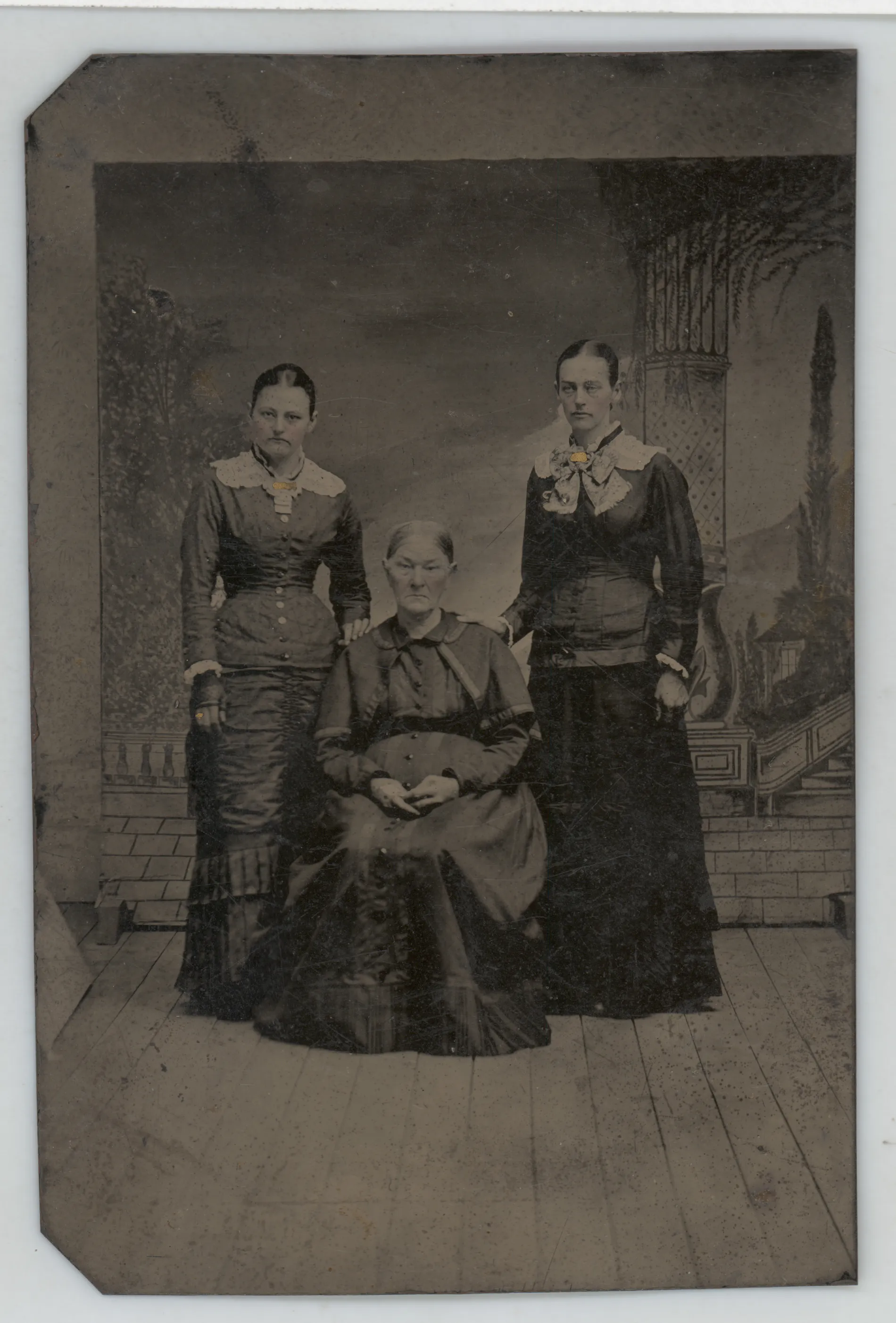 This photograph shows three women, two standing and one sitting. The woman on the right may be Nancy C. Atkinson Swann. Her appearance matches other photographs of Nancy that are available. The other two women cannot be identified with certainty. They may be relatives of Nancy, potentially her stepmother Fannie Bledsoe Atkinson and her sister Artemissia.