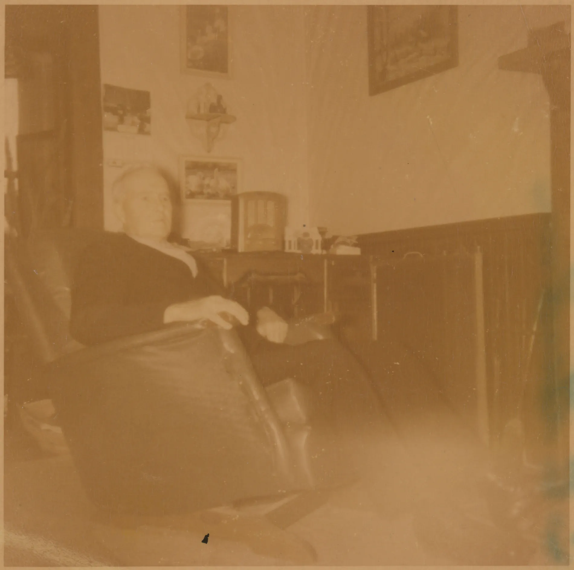 This is a photograph of a seated C.E. Girdner at the home of Sam and Loveta McKinstry. The photograph shows the interior of their home. This was likely taken in 1953.