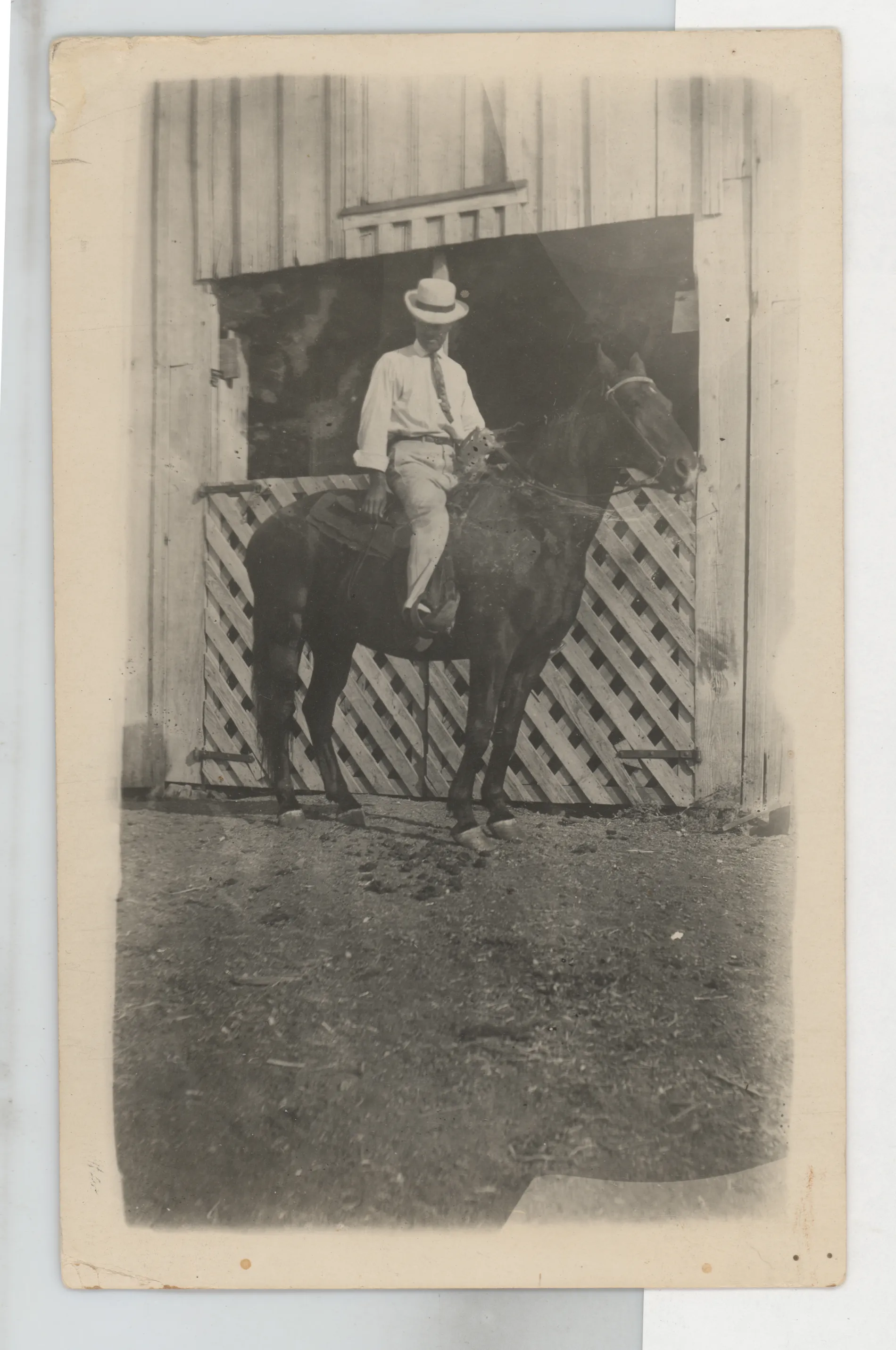 This photograph depicts C.E. Girdner on a horse next to a barn in 1911.