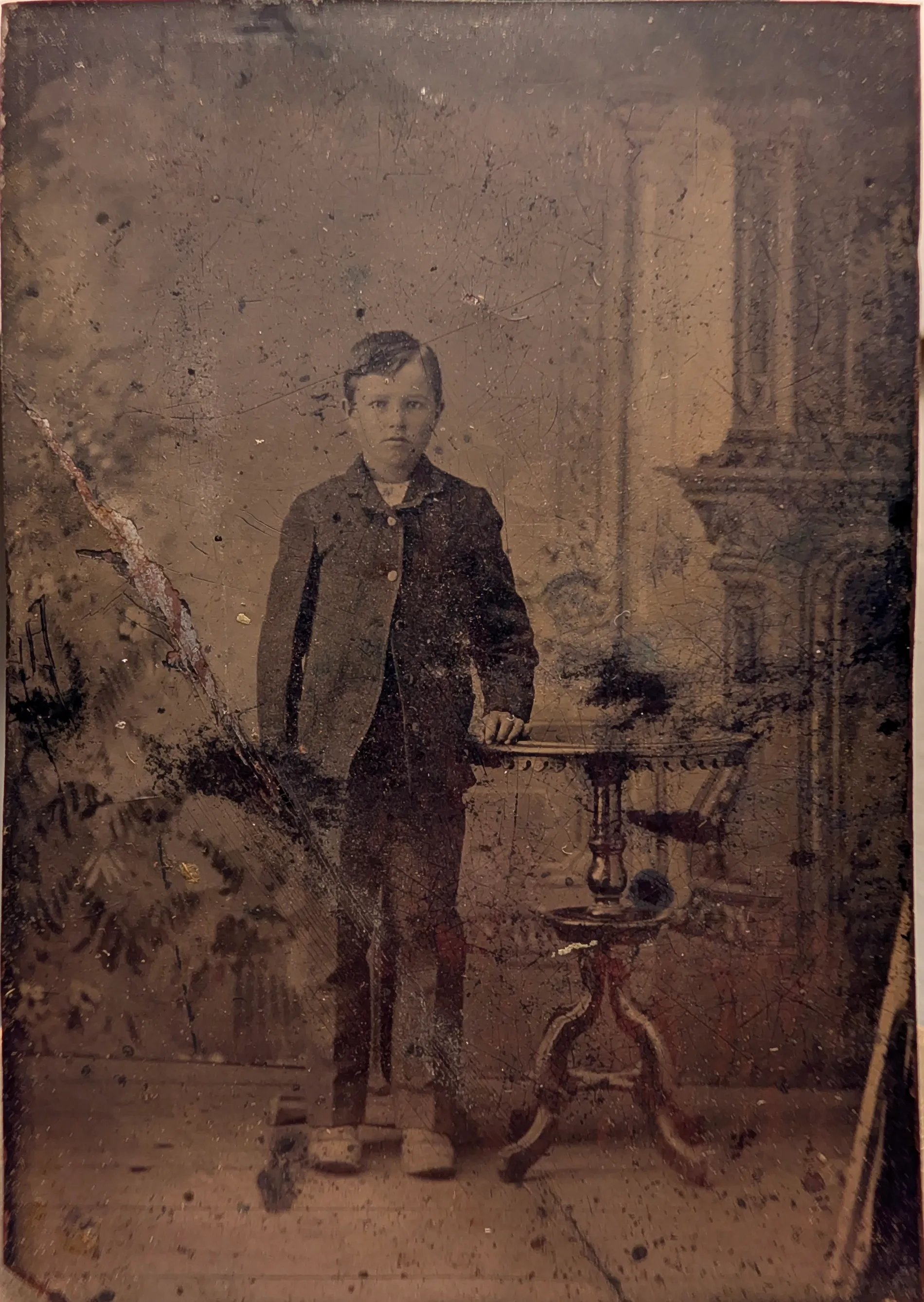 This is a photograph of a young C.E. Girdner. His age is estimated to be between 8 and 12 years old. This tintype is in a dual folding frame with a photograph of a young Nannie Swann, whom he would later marry.
