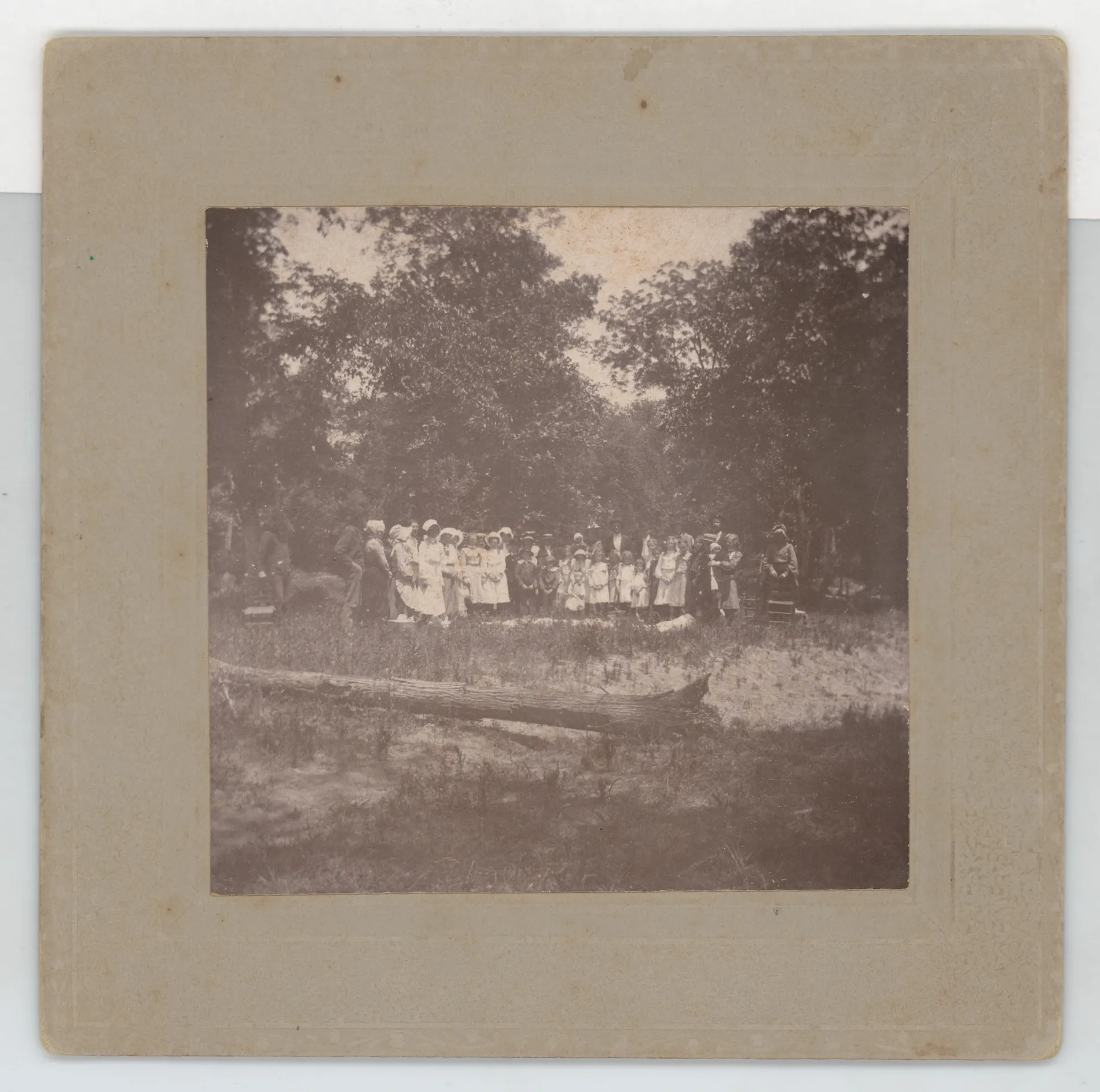 This photograph depicts a picnic on Sulfur River. The people in the photograph are mostly unidentifiable, but Malcom Swann may be on the left.