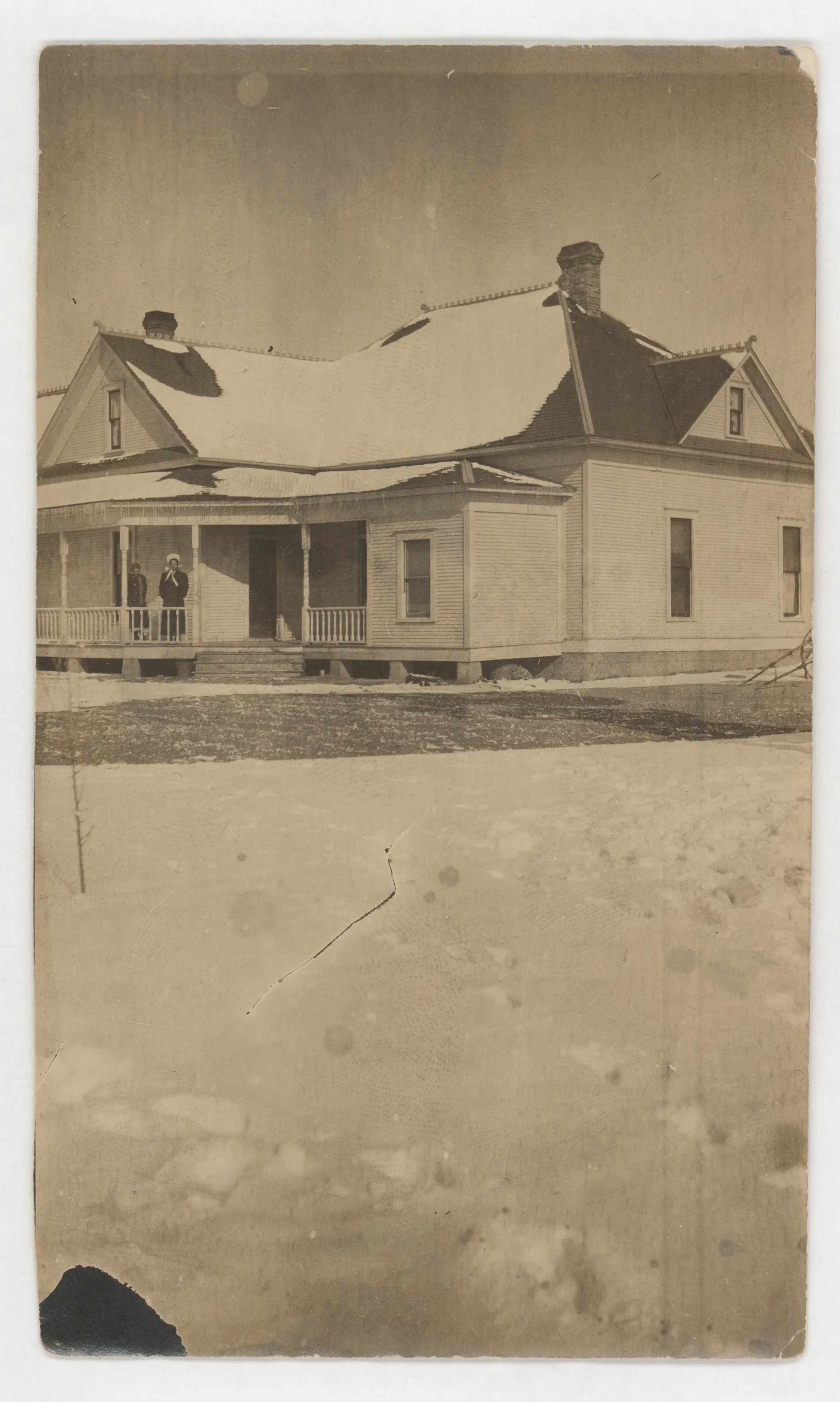 This photograph depicts the first house of Austin Swann and his three girls as it looked in 1908 when they came to Hagerman. There are two women on the front porch of this house, but the resolution of the photograph prevents certain identification.
