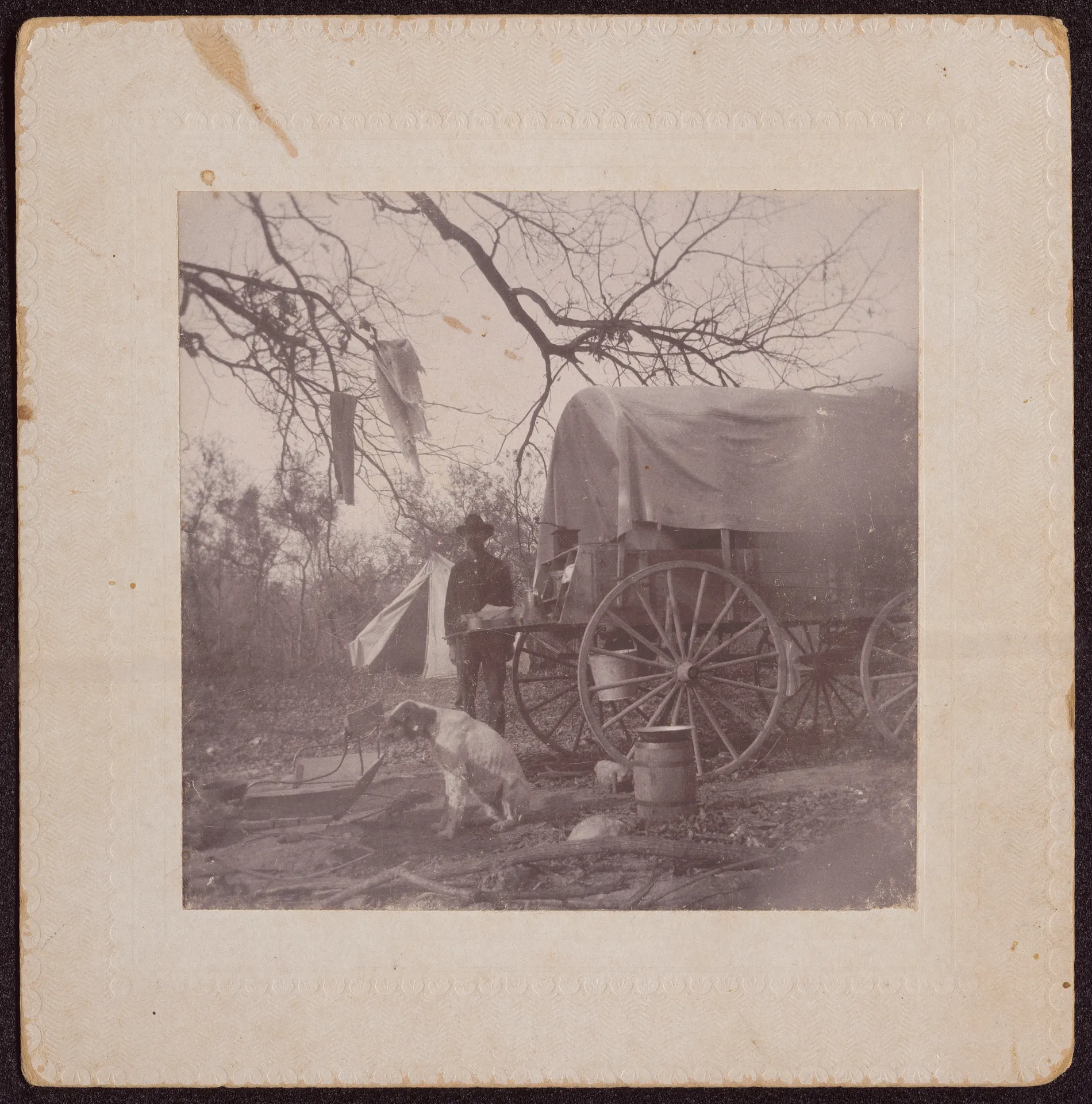 This photograph depicts Austin Swann near a wagon on a hunting or fishing trip. The location of this photograph is unknown, but presumed to be in Texas.