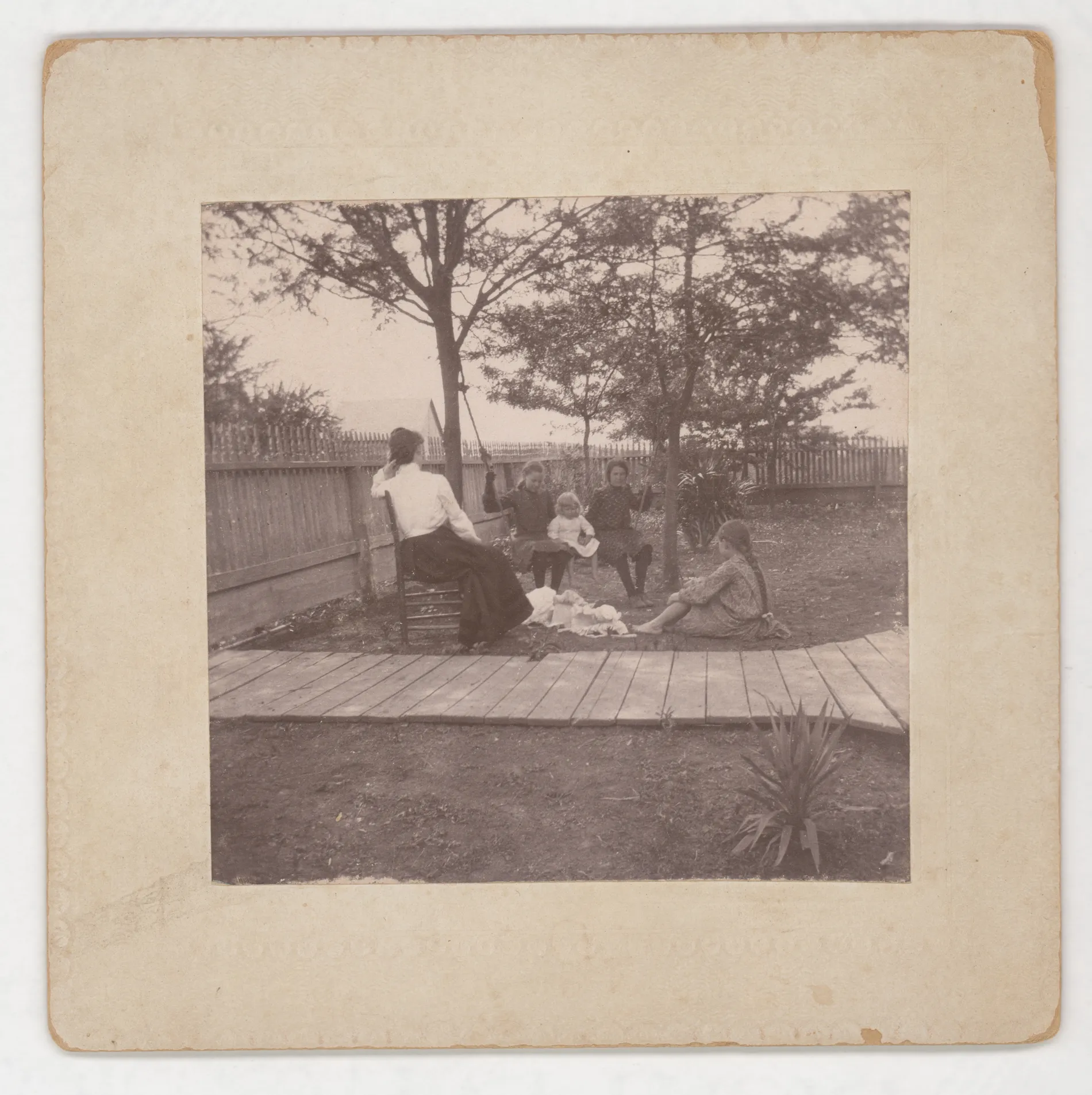 This photograph depicts Eva Swann, Minnie Swann, and Loveta Swann. It also depicts Vena Girdner and Zera Girdner.