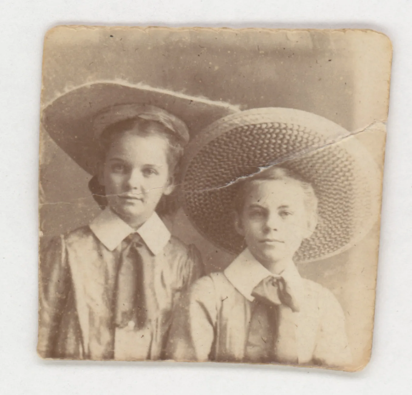 This is a candid snapshot of Loveta Swann and Mable Swann, who was the daughter of John Milton Swann and Gussie Cody Swann. Both are wearing sombrero-style hats.