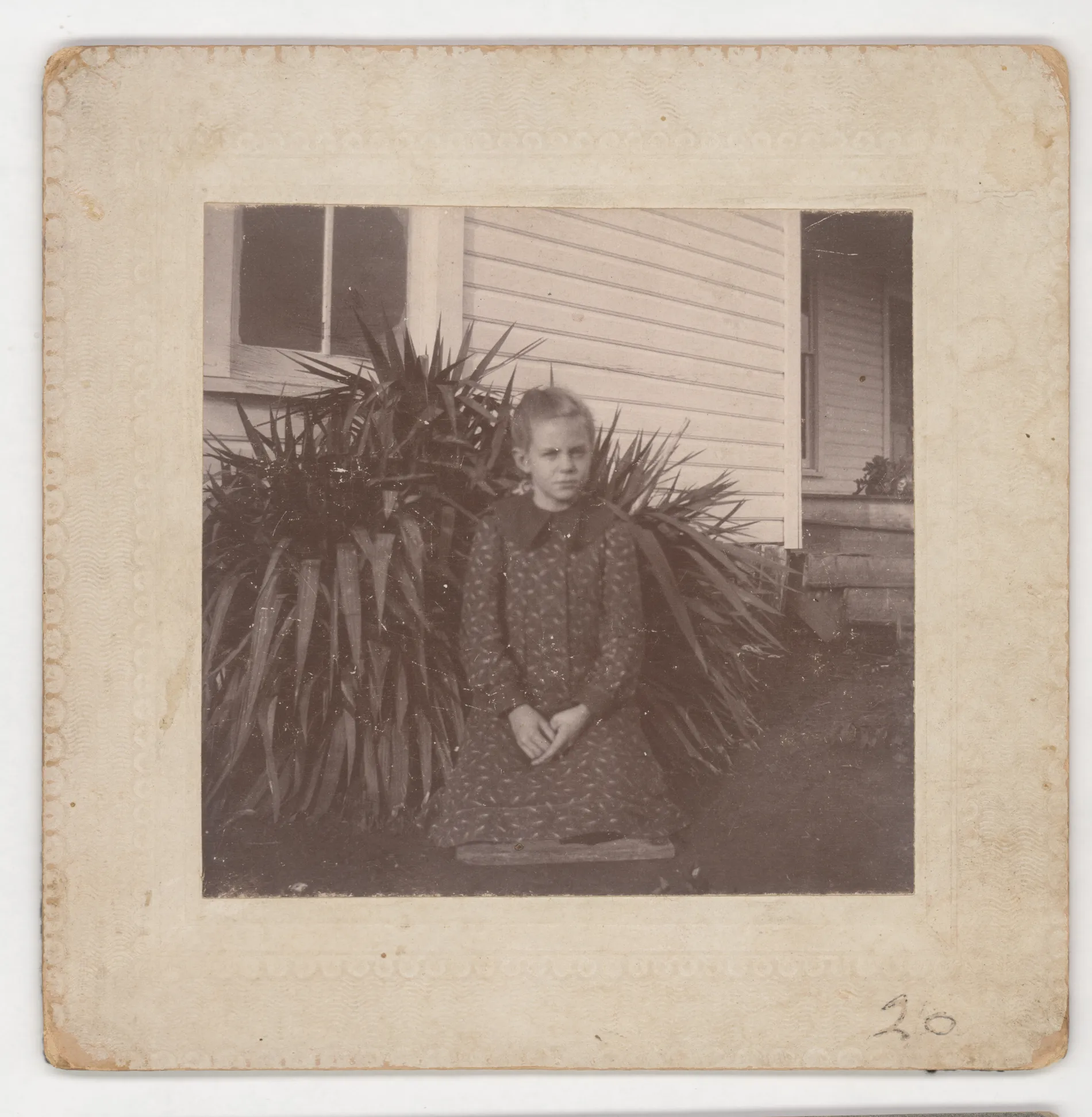 This photograph depicts Loveta Swann standing in front of her home in Jacobia, Texas between the years 1901 and 1903.