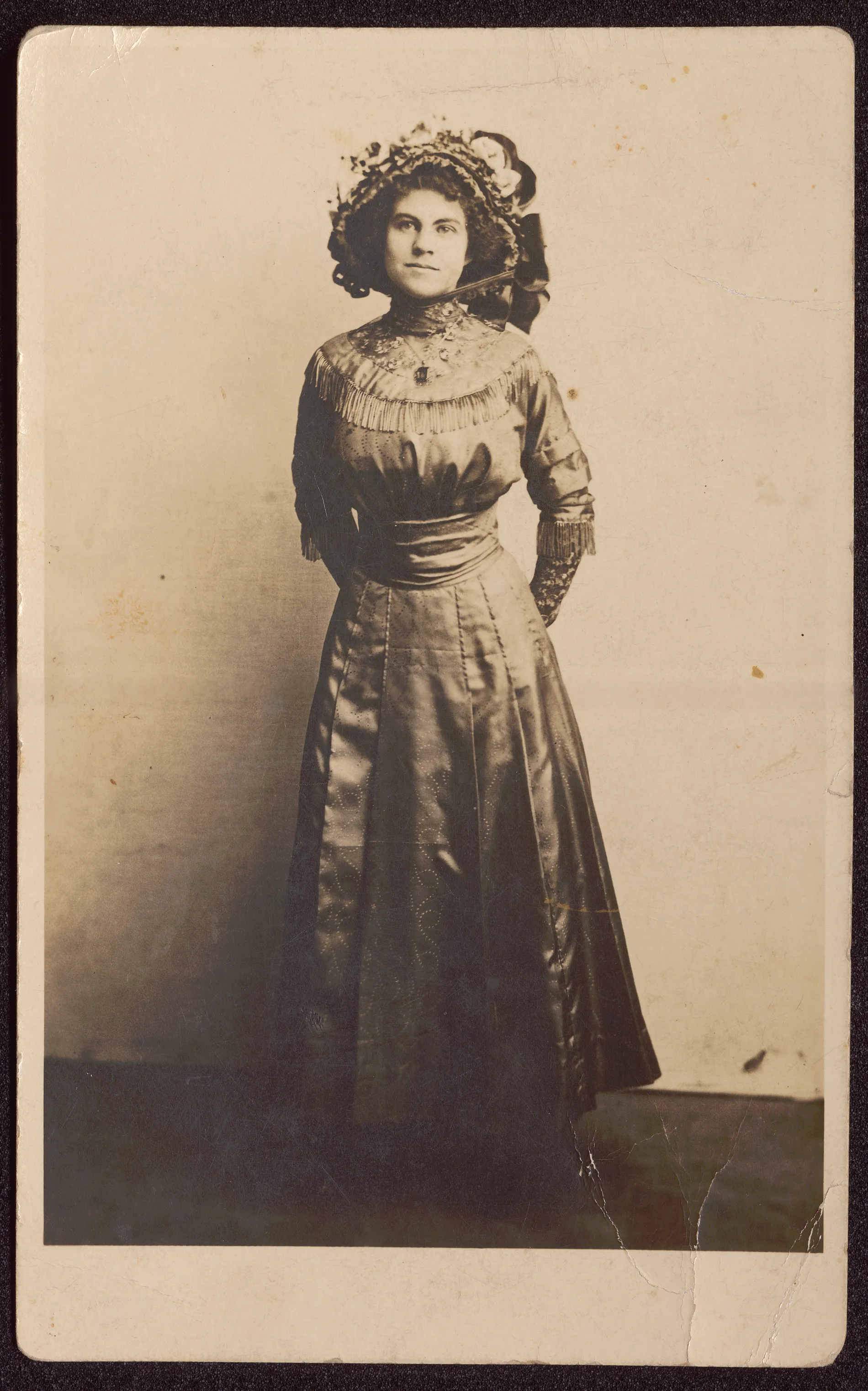 This photograph depicts Loveta Swann in her baccalaureate dress and hat in 1911. The family had moved to New Mexico by this date, so it was likely taken in New Mexico.