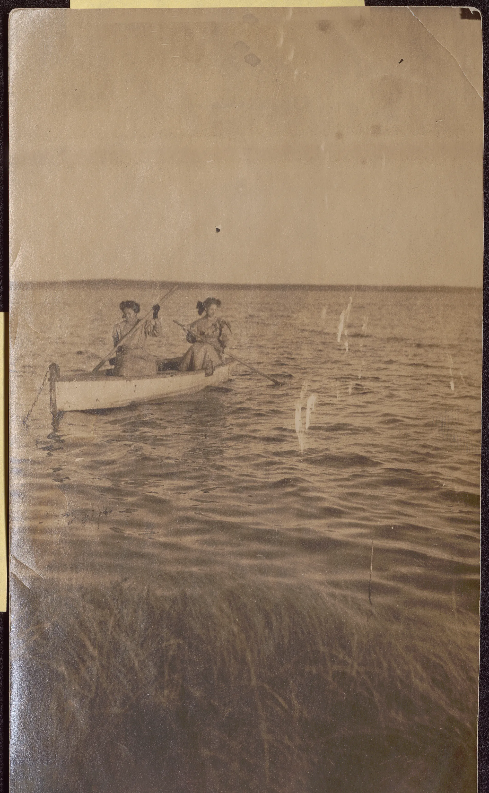 This photograph depicts Minnie and Loveta Swann rowing a boat on a lake in New Mexico.