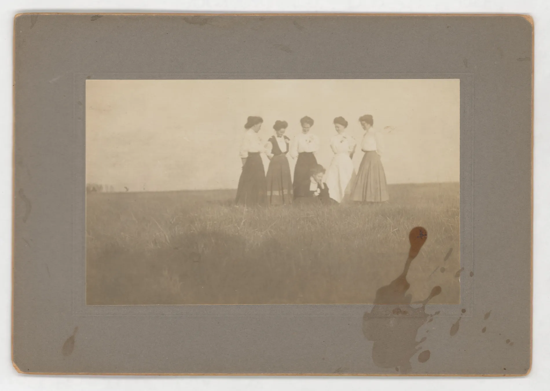 The photo depicts Minnie Swann sitting down in front of five of her friends. This group was known as the "Naughty Six." 