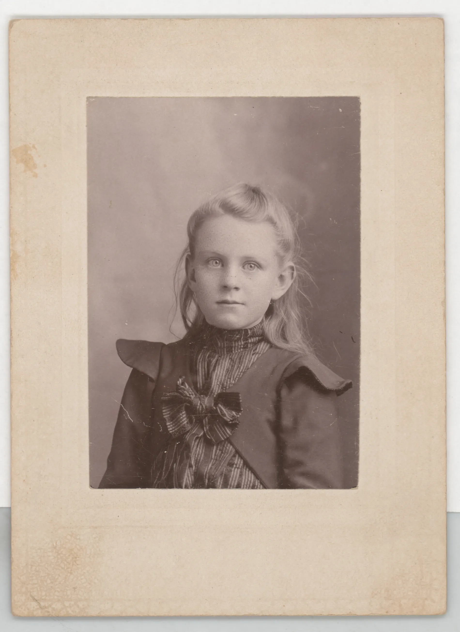 This photograph depicts Minnie Swann as a child. She appears to be between the ages of 7 and 10, which would likely place this photograph between the dates of 1897 and 1900. The family still lived in Jacobia at this time.