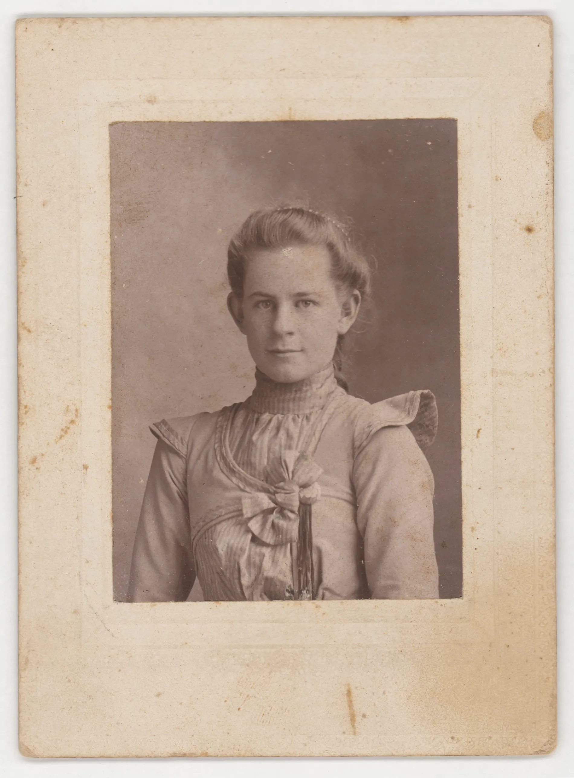 This photograph depicts Eva Swann between the ages of 14 and 18, which would place this photograph between 1900 and 1904 while the family still resided in Jacobia, Texas.